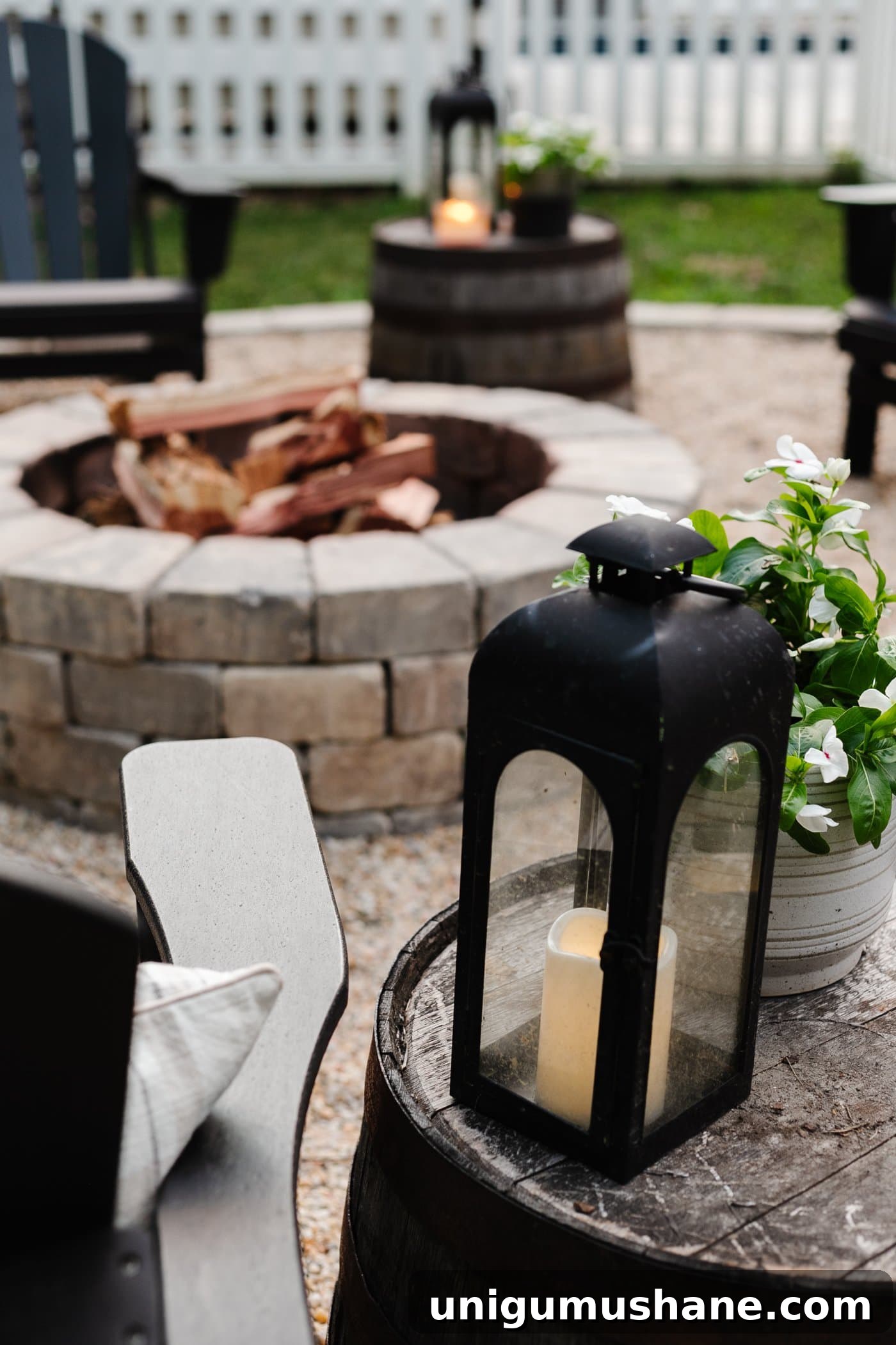 Backyard Lighting Ideas You Can Install Yourself 12 black lantern beside an Adirondack chair at a backyard fire pit