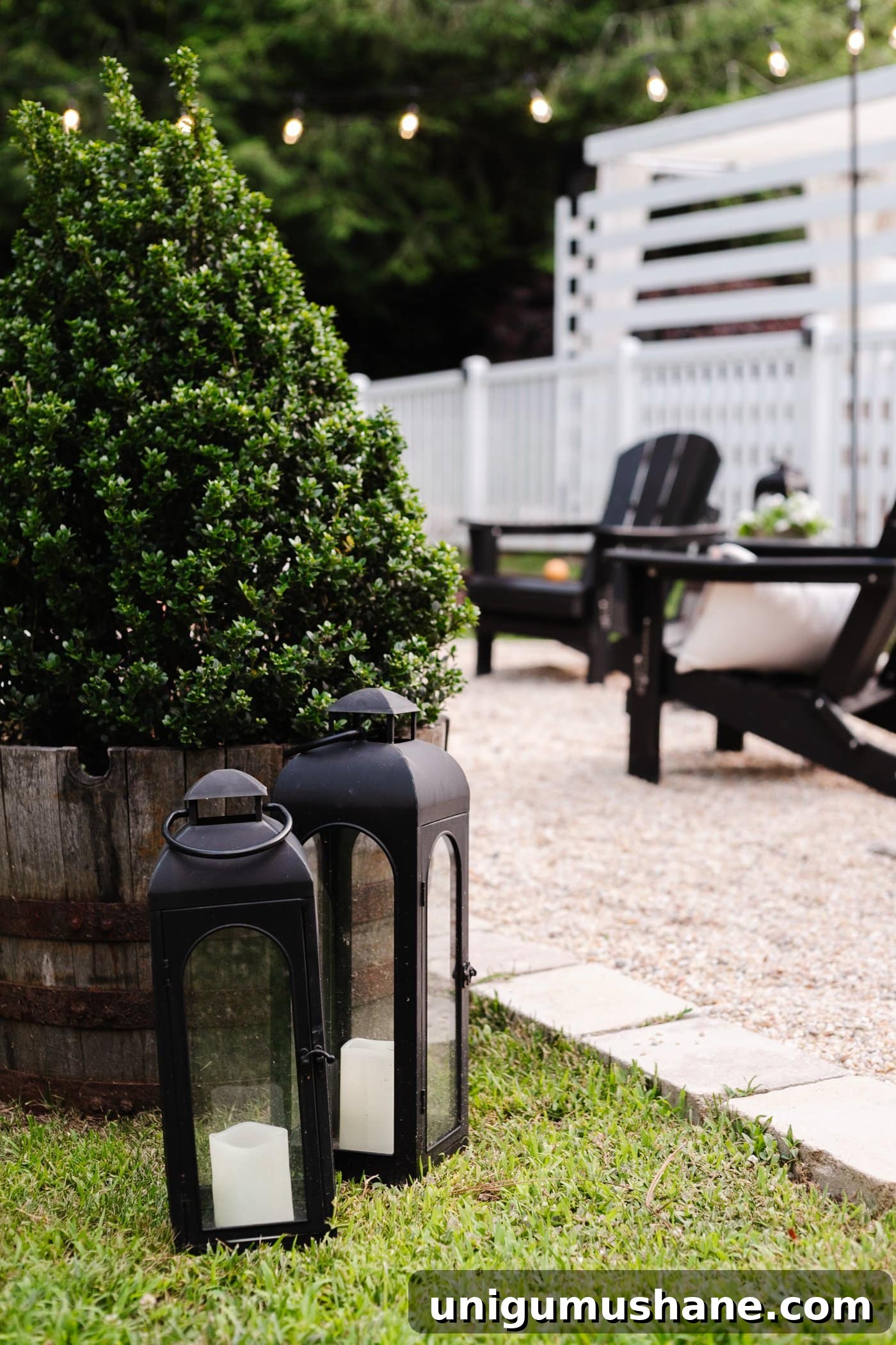 Backyard Lighting Ideas You Can Install Yourself 13 black lanterns beside a pea gravel backyard fire pit and boxwood tree