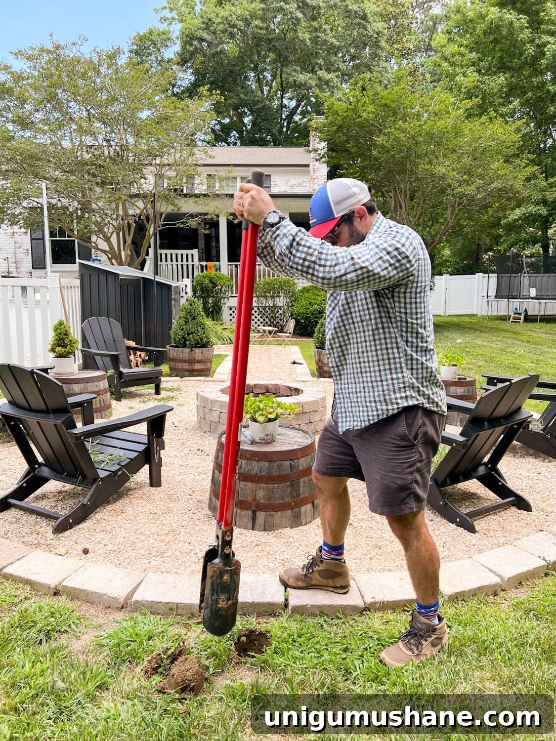 How to Hang Outdoor String Lights Anywhere in Your Backyard 13 using a post hole digger to dig holes for string light poles around a fire pit