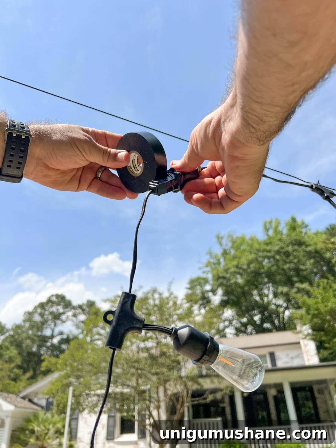 How to Hang Outdoor String Lights Anywhere in Your Backyard 20 wrapping two string light strand plugs with black electrical tape