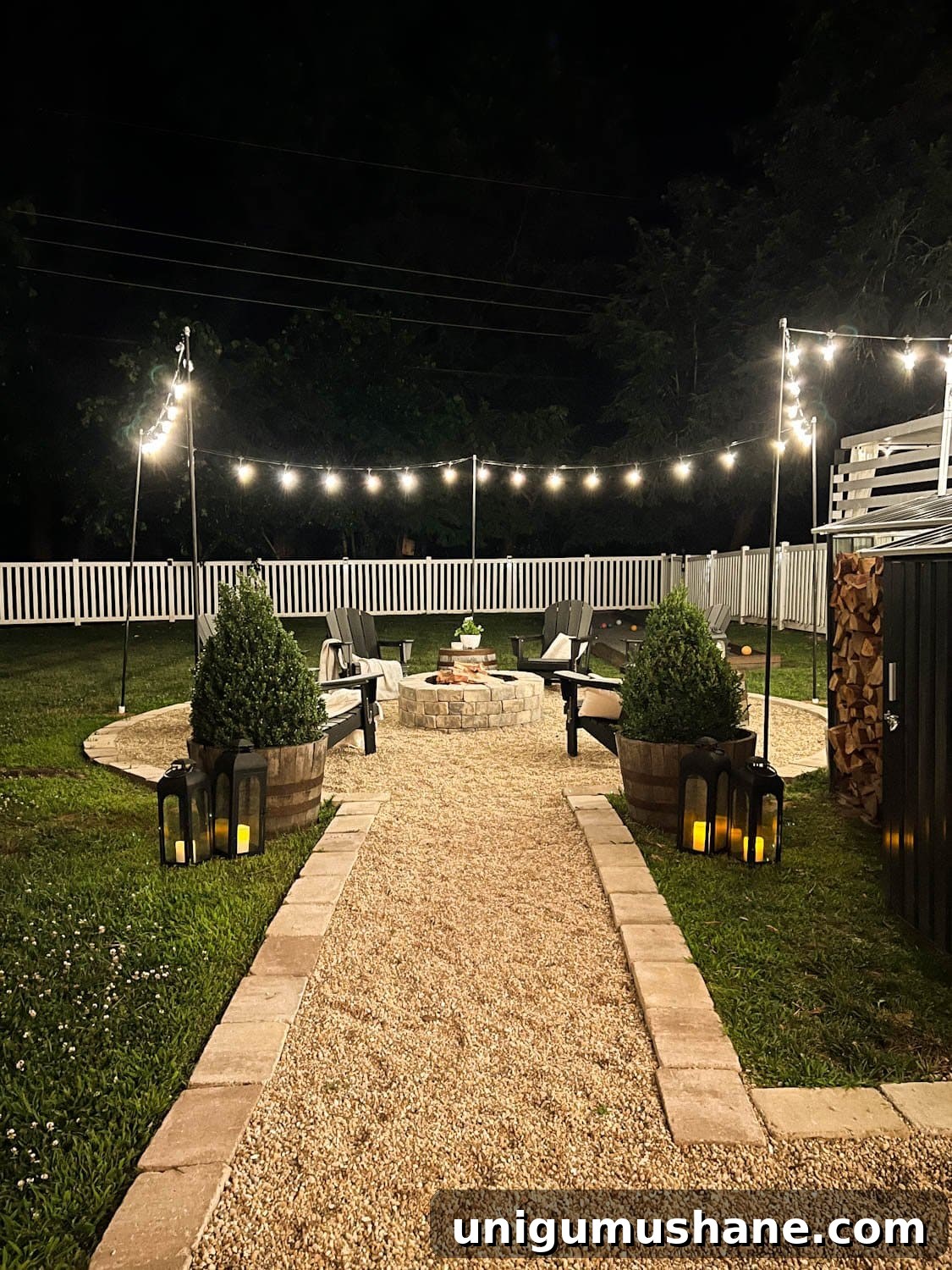 How to Hang Outdoor String Lights Anywhere in Your Backyard 22 hanging string lights around a fire pit with poles at night