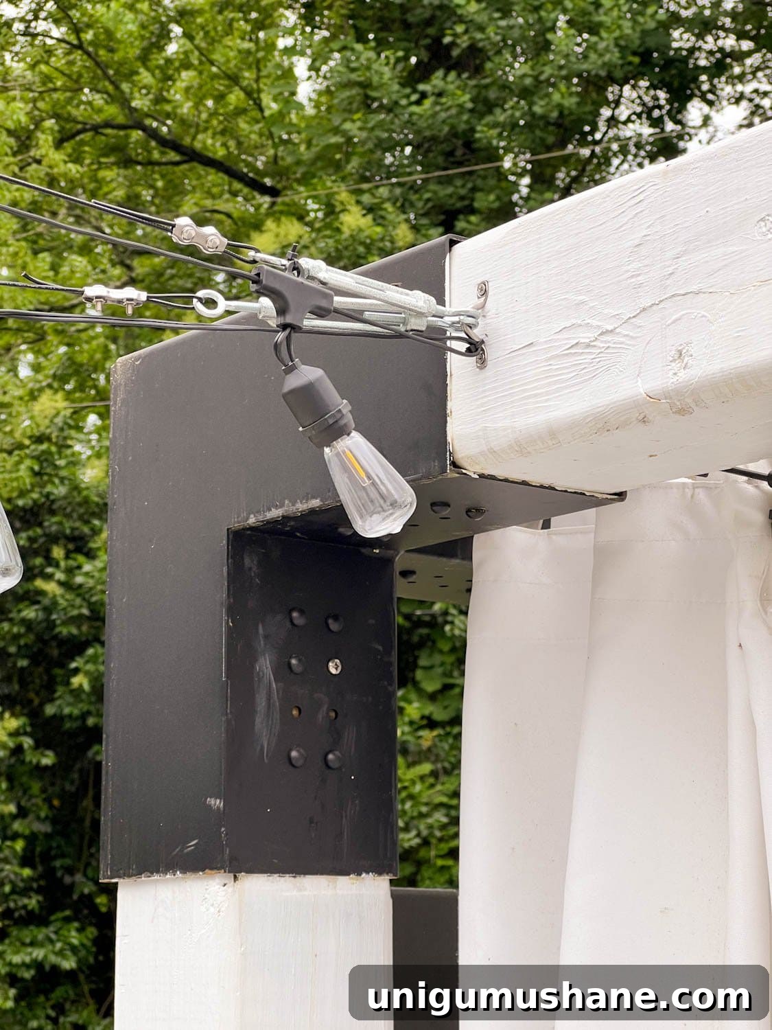 How to Hang Outdoor String Lights Anywhere in Your Backyard 30 hanging lights from a pergola using cables