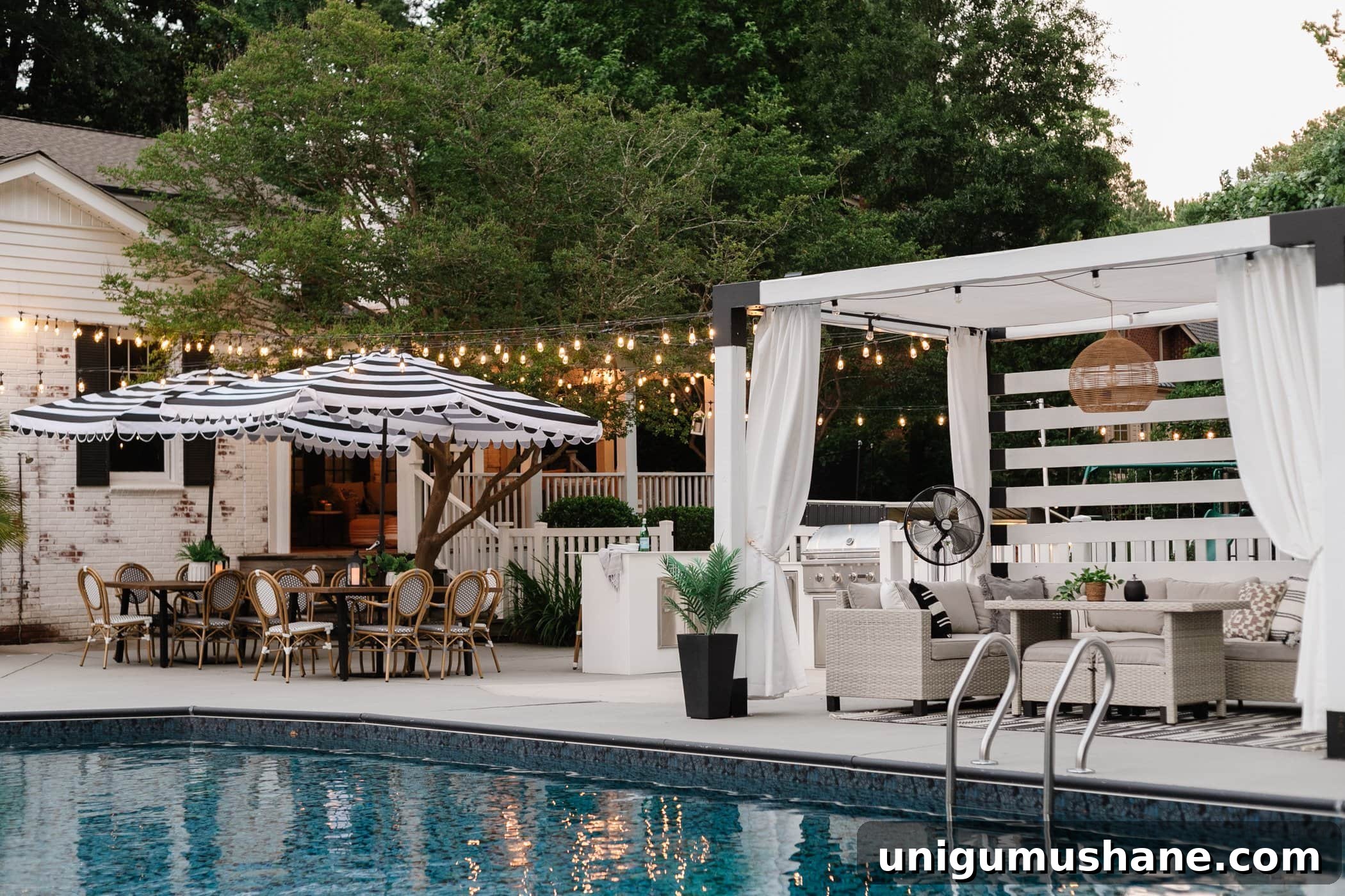 How to Hang Outdoor String Lights Anywhere in Your Backyard 34 string lights hanging around a pool with pergola and outdoor dining tables