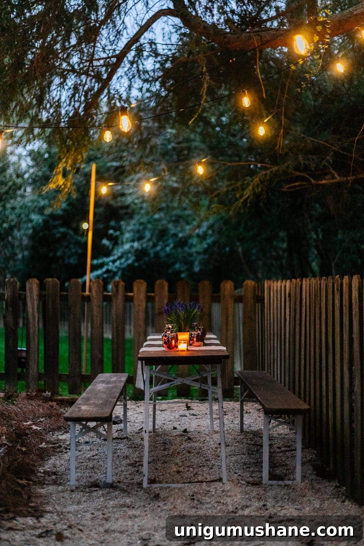 How to Hang Outdoor String Lights Anywhere in Your Backyard 36 solar lights hanging from a tree above an outdoor table