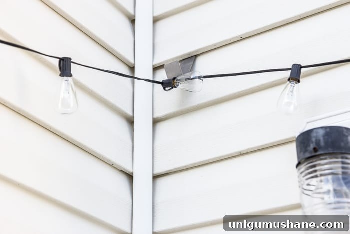 How to Hang Outdoor String Lights Anywhere in Your Backyard 41 string lights hanging from siding clips