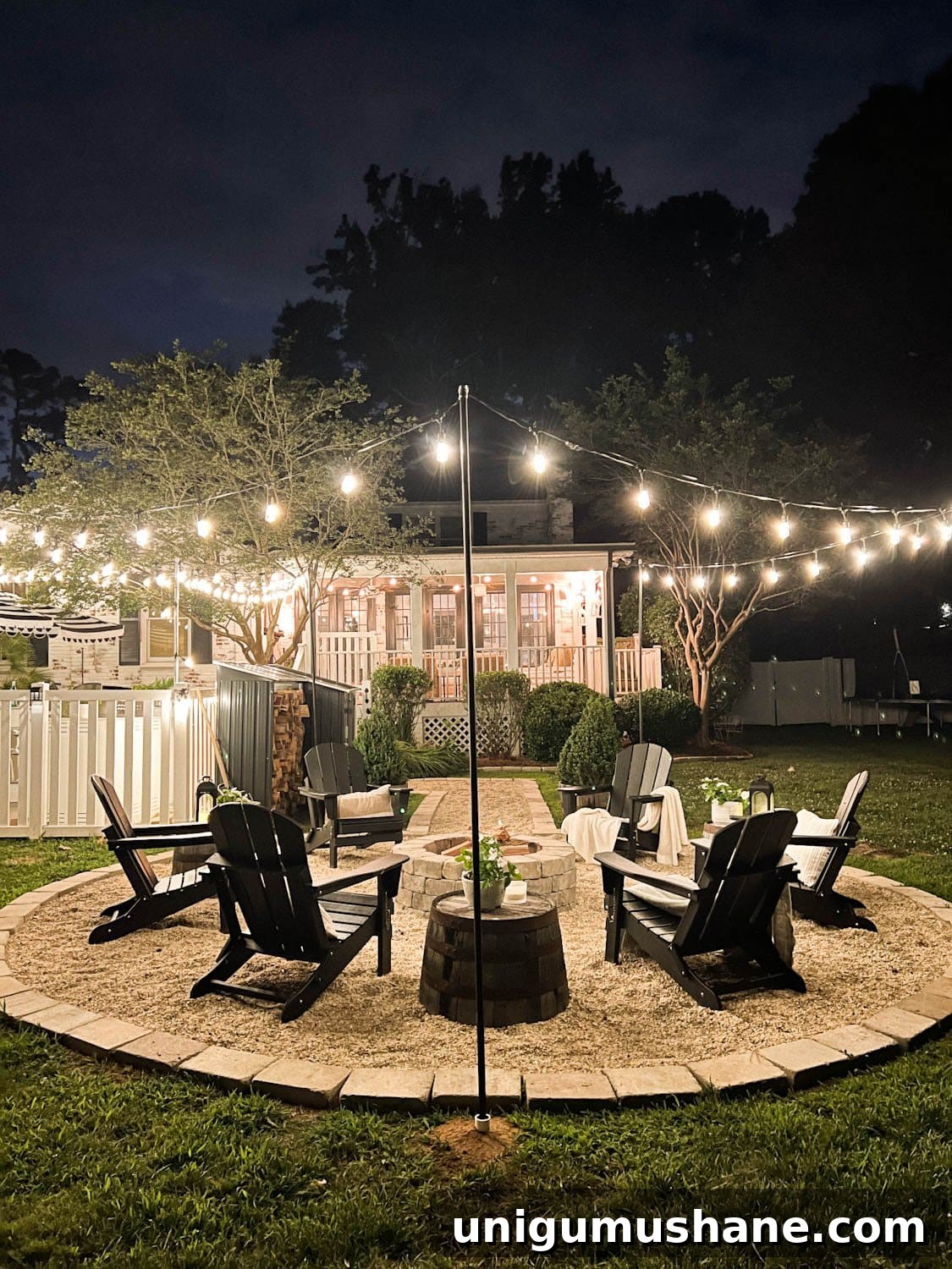 How to Hang Outdoor String Lights Anywhere in Your Backyard 8 lights hanging around a fire pit with string light poles in the ground