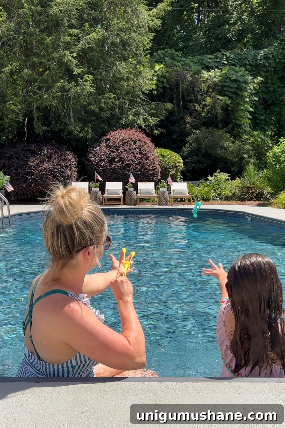 Must-Have Pool Toys for Kids and Adults This Summer 2 mother and daughter playing with swimming pool toys in a backyard
