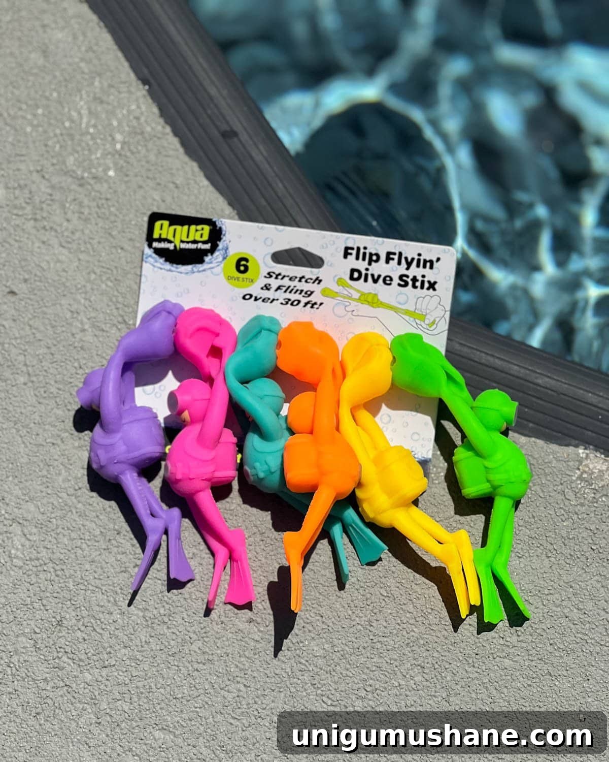 Must-Have Pool Toys for Kids and Adults This Summer 10 pack of Flip Flying Dive Stix pool toys on the side of a swimming pool