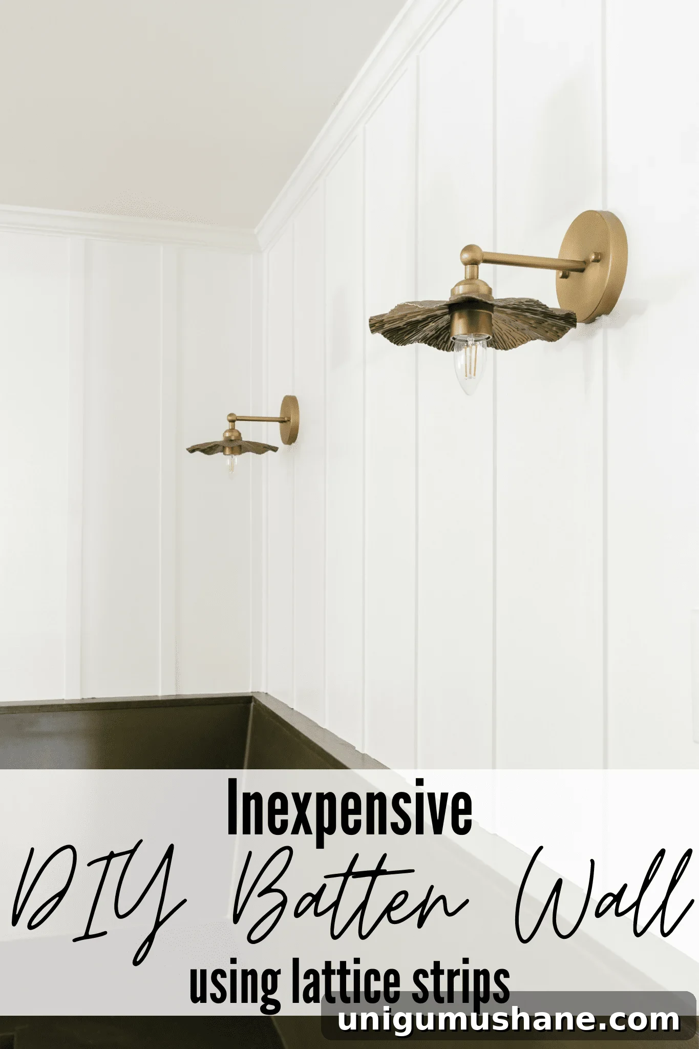 A DIY batten wall behind brass vintage sconces above a green banquette bench