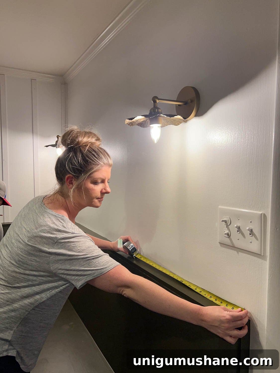 measuring a wall to place lattice strips for a DIY batten wall