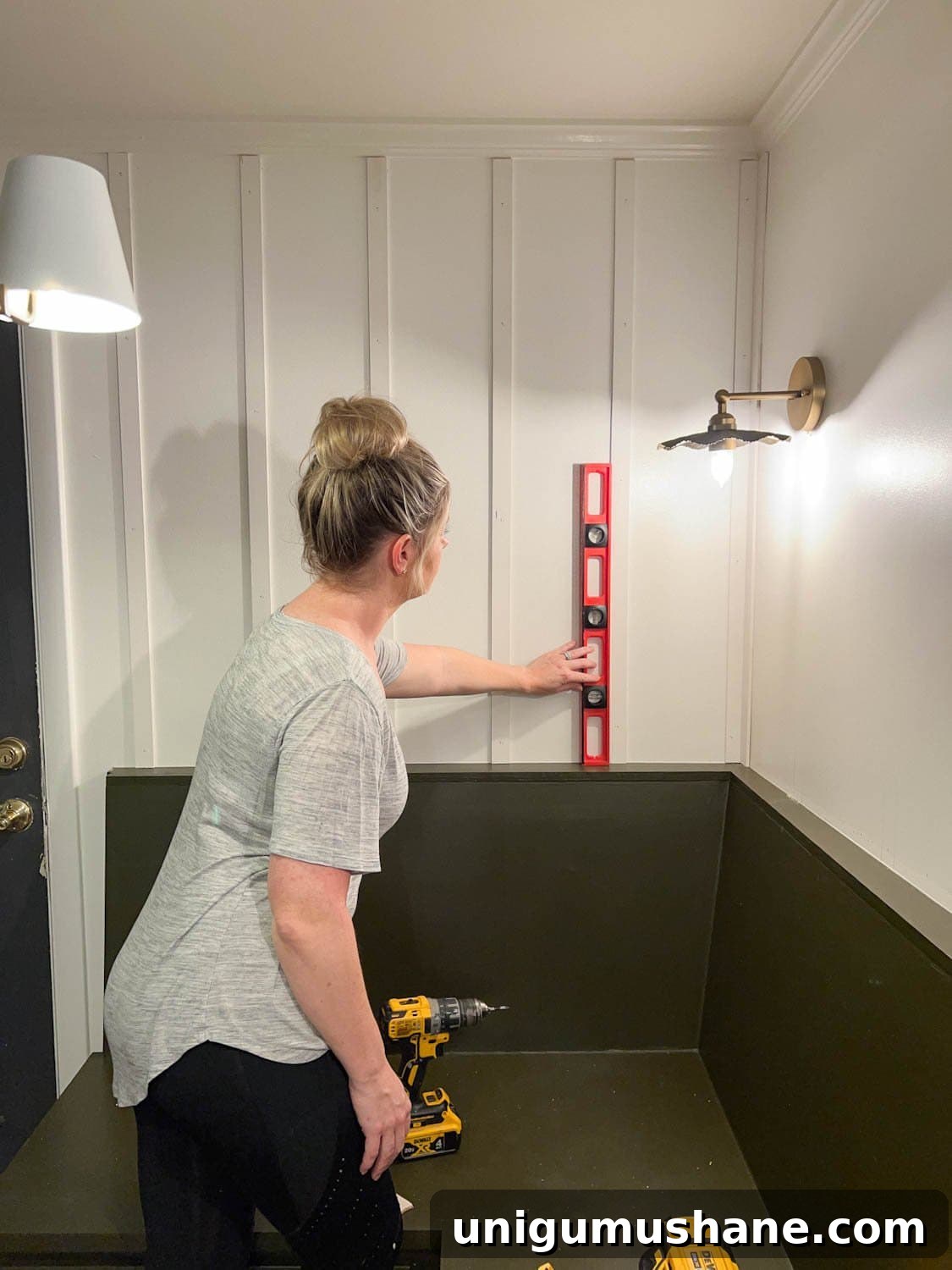 checking with a level to make sure lattice strips are perpendicular 