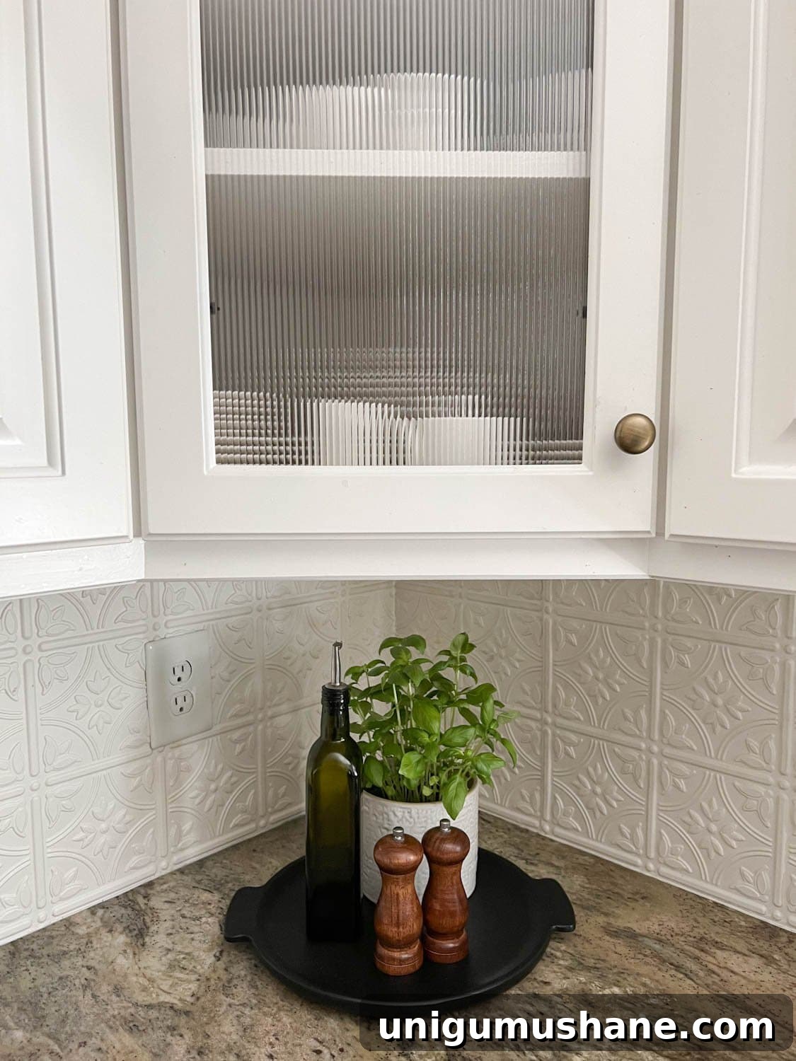 Decorative Window Film Ideas to Transform Home Glass on a Budget 4 reeded glass cabinet and kitchen countertop decorative tray with potted herbs, bottle of olive oil, and salt and pepper grinders