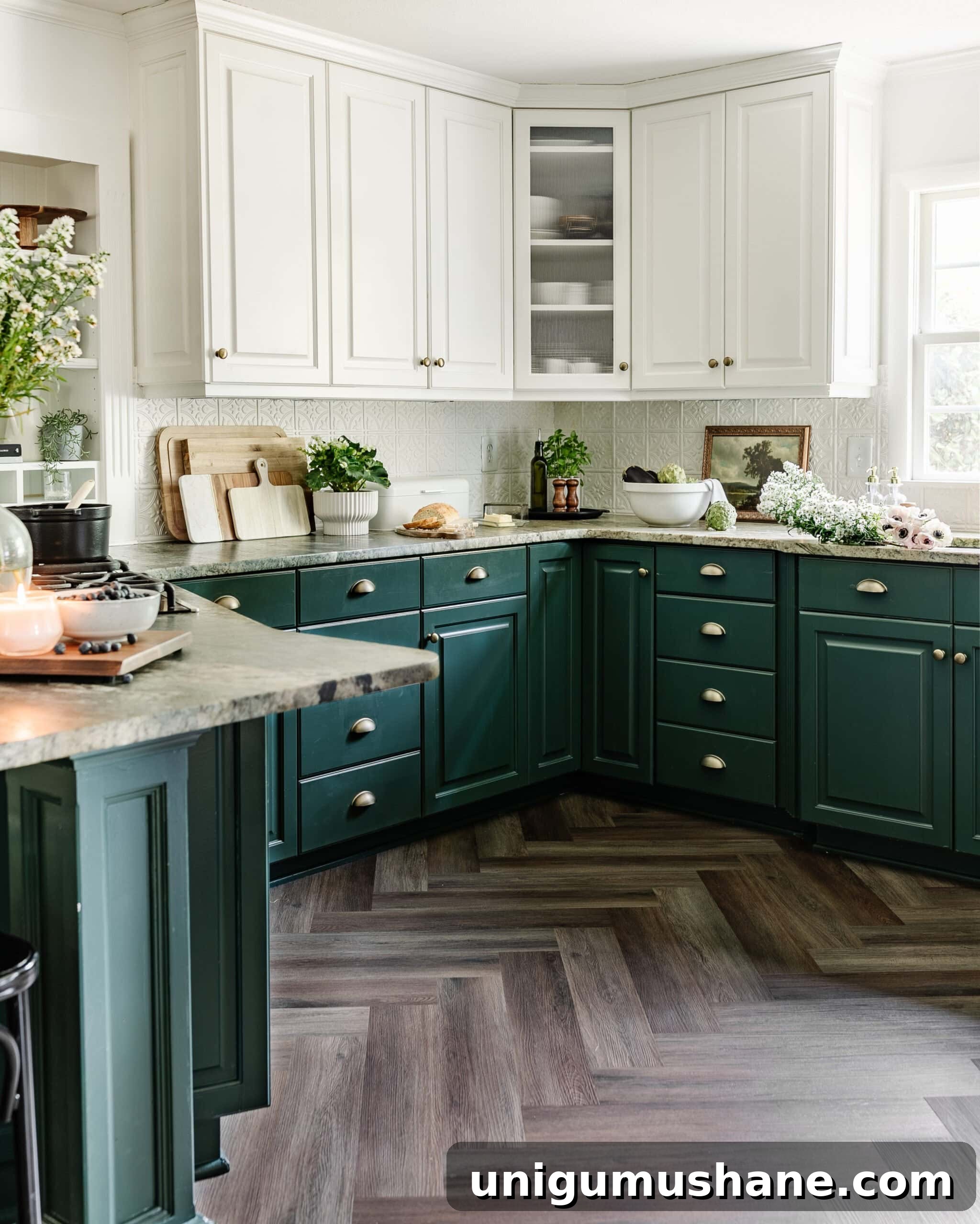 kitchen with green lower cabinets and white upper cabinets, herringbone LVP flooring