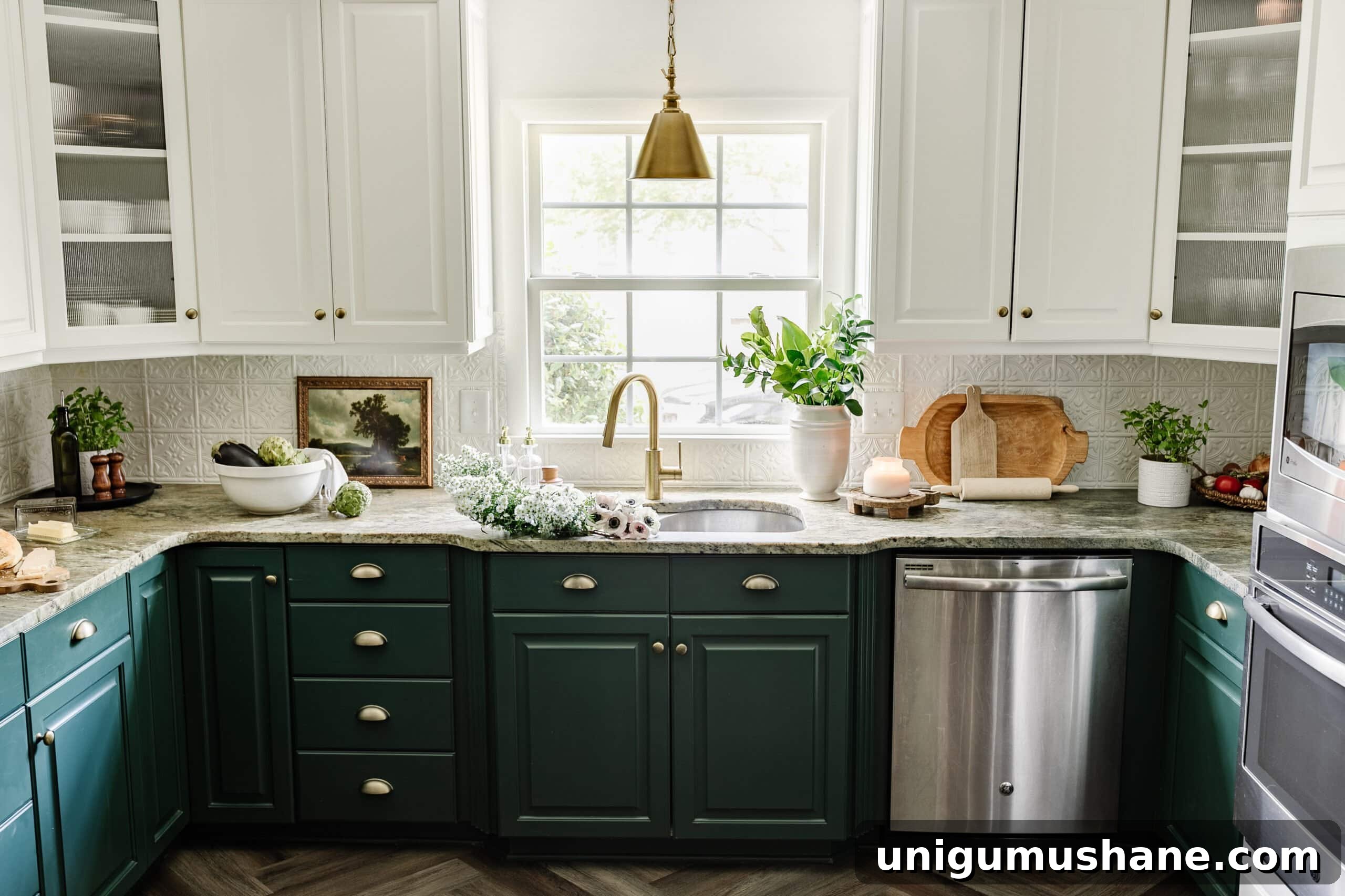 kitchen sink in front of window with white and green cabinets