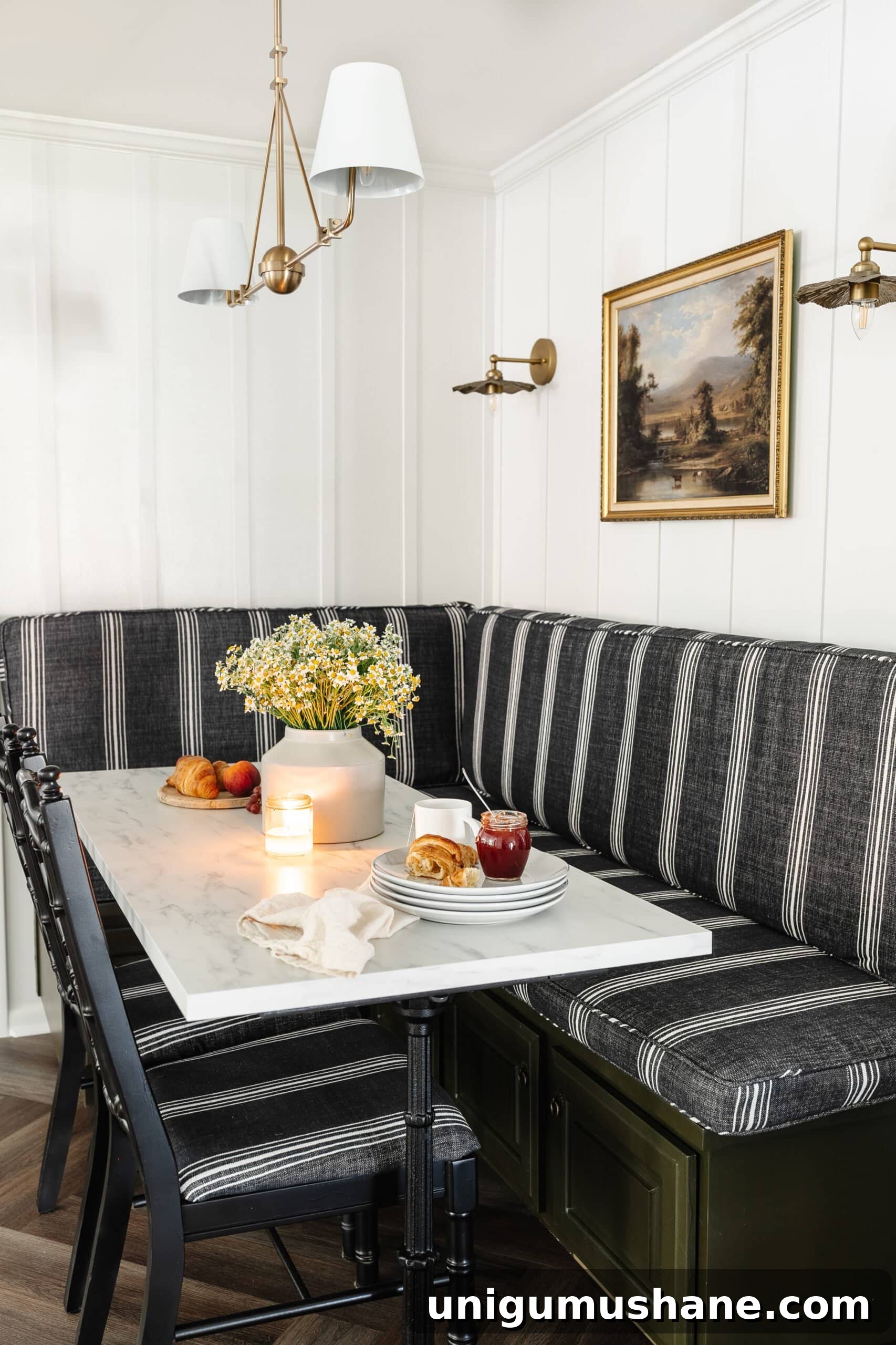 Parisian Bistro-Inspired Breakfast Nook Decor Ideas 11 charcoal striped booth in a corner breakfast nook with brass chandelier and wall sconces and marble dining table