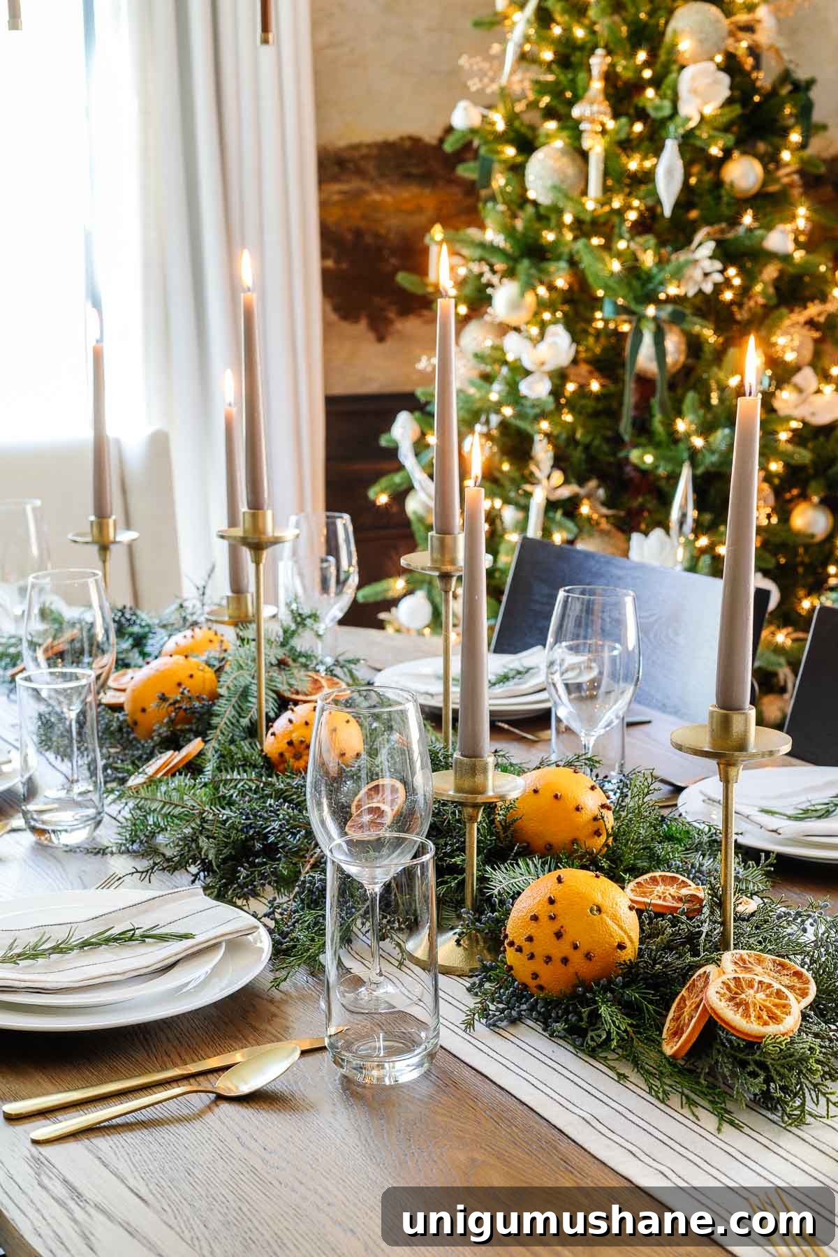 How to Set an Elegant Dinner Table for Any Occasion 12 Christmas dining table centerpiece with leaves and dried oranges slices and candlesticks