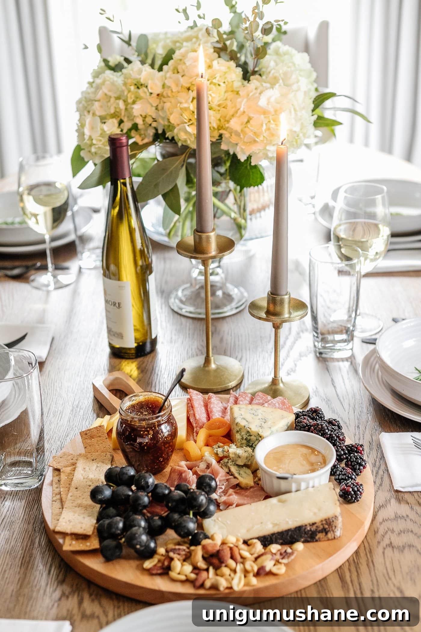 How to Set an Elegant Dinner Table for Any Occasion 13 charcuterie board, candlesticks, and vase of flowers for simple dinner table decor