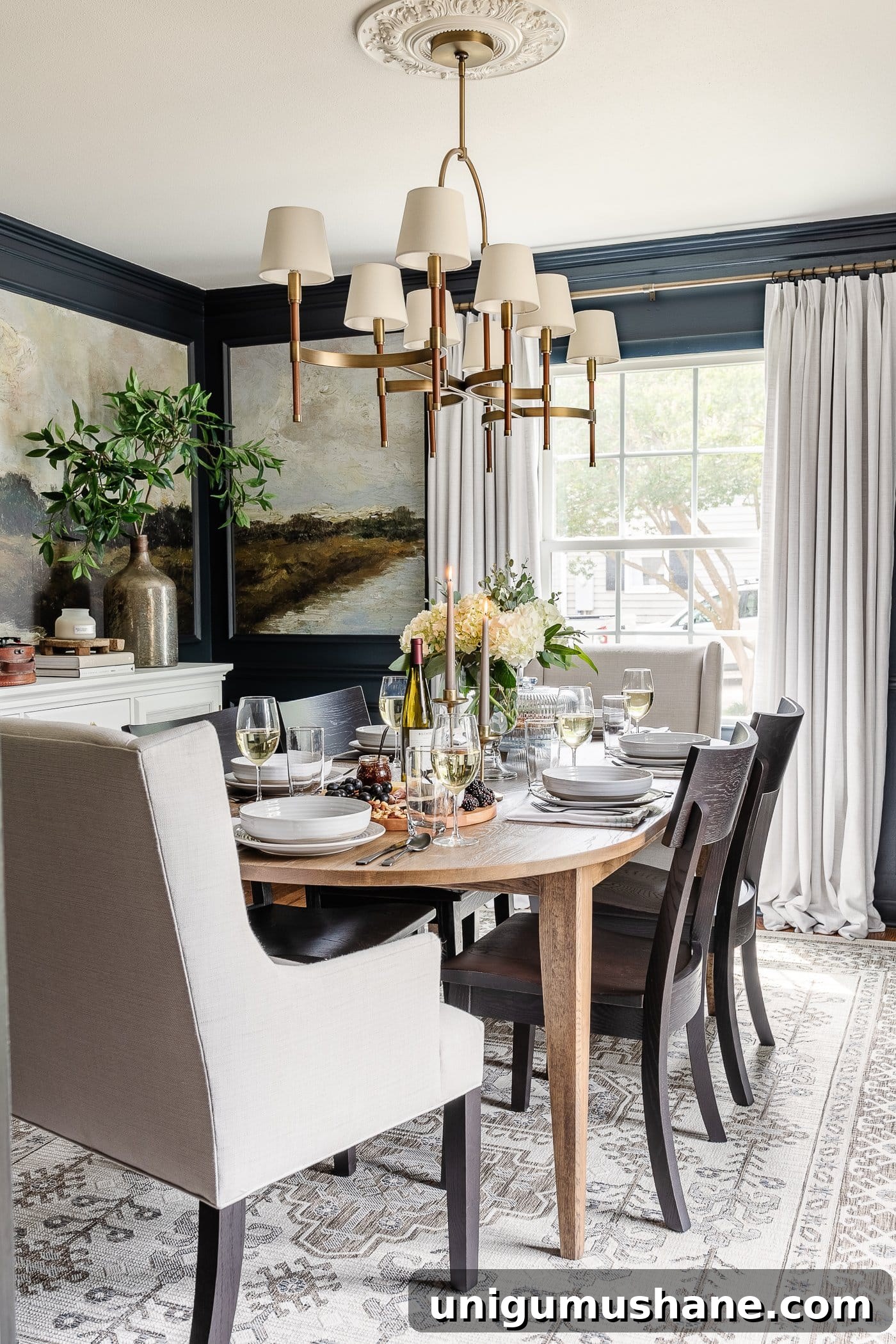How to Set an Elegant Dinner Table for Any Occasion 18 dining room with mural wallpaper, shaded chandelier, linen chairs, black chairs, oval dining table, and simple dinner table decor
