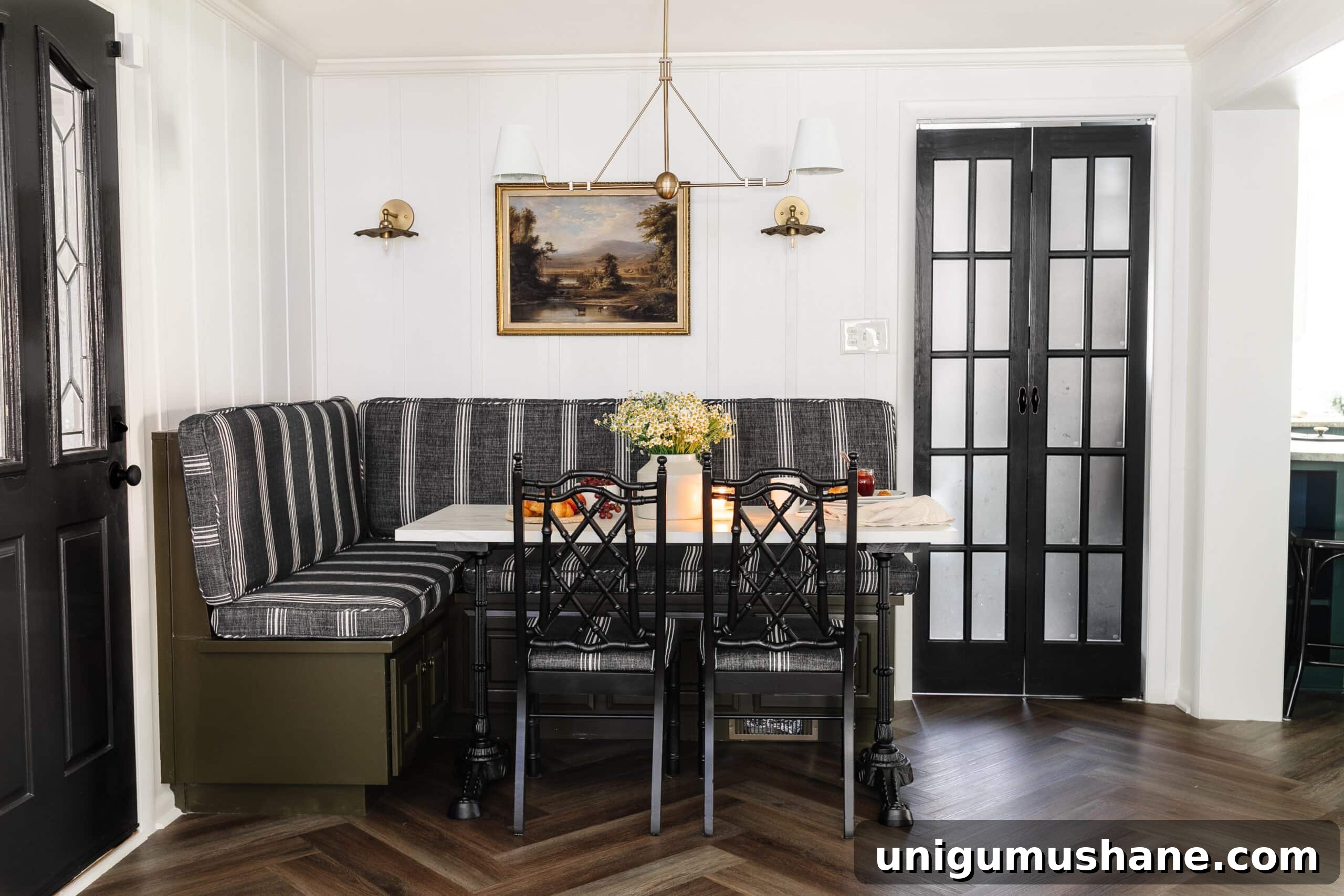 5-Year Home Transformation: Before and After Tour 19 cottagecore breakfast nook with banquette, shaded chandelier, bifold French door, herringbone floor, and marble bistro table