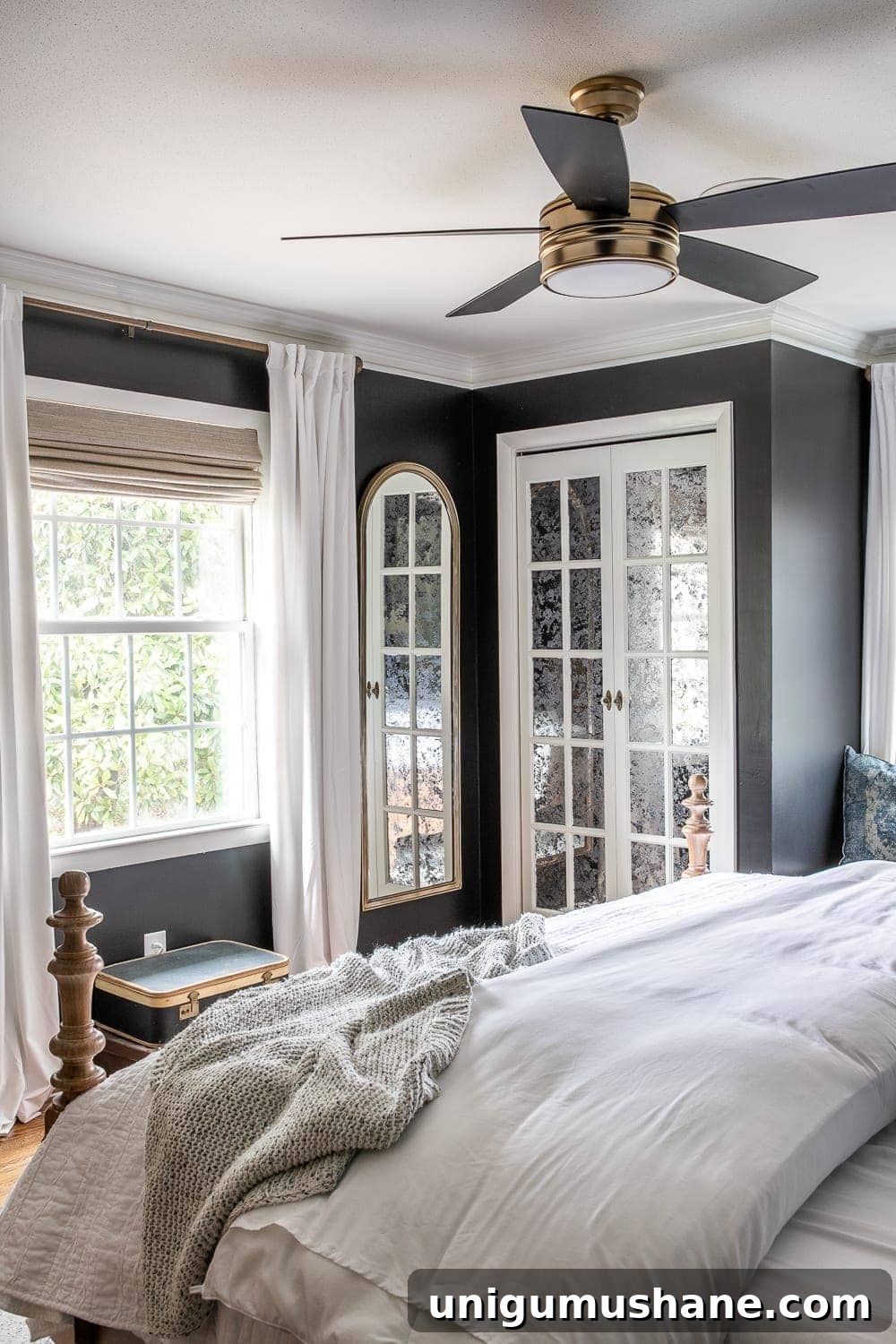 5-Year Home Transformation: Before and After Tour 40 black bedroom with white curtains, mirrored closet doors, ceiling fan, and upholstered wood bed