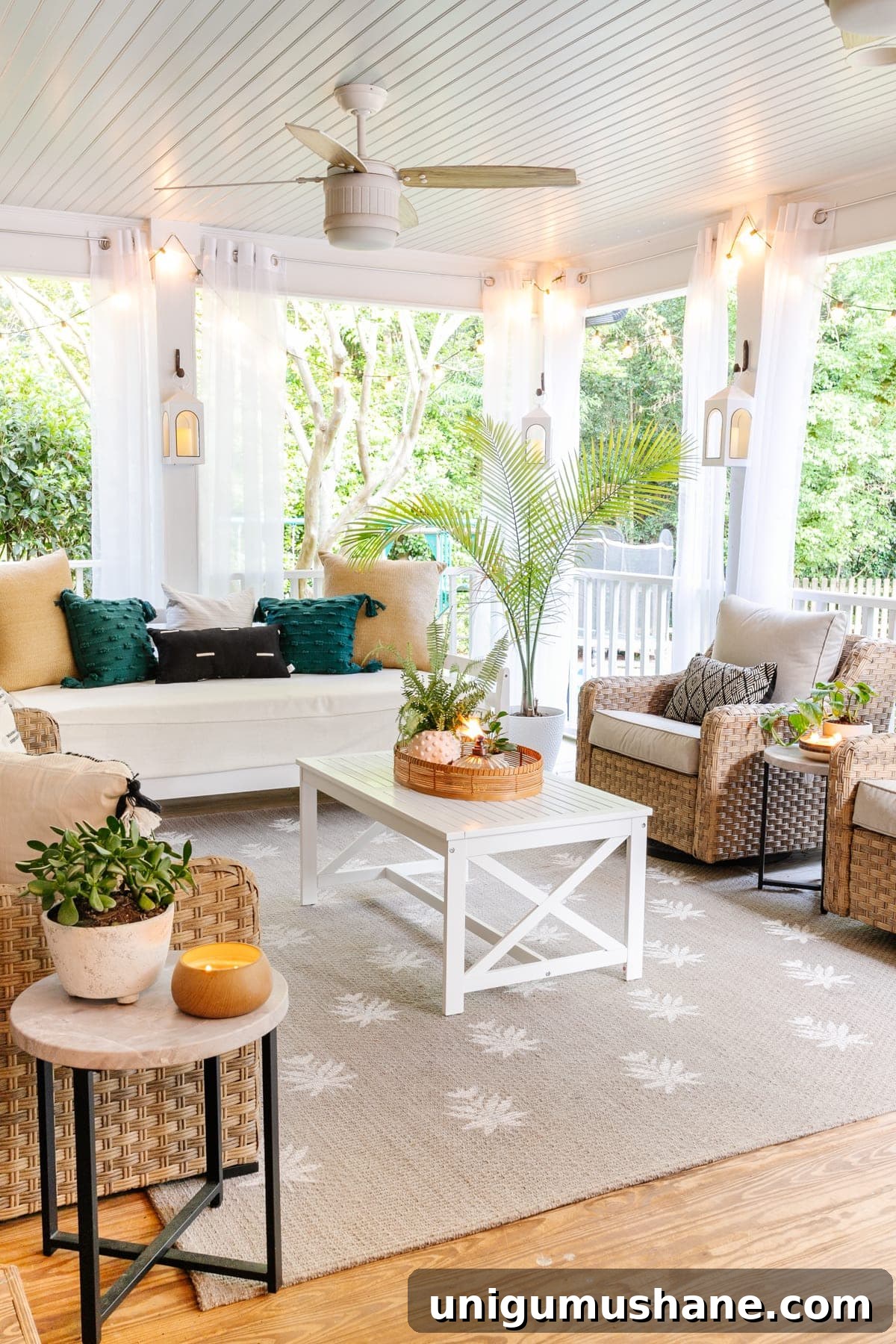 5-Year Home Transformation: Before and After Tour 46 back porch after with mosquito net curtains, string lights, outdoor day bed, outdoor conversation set, and floral block outdoor rug