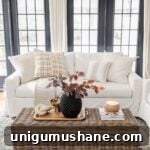Fall Pillows That Transition Seamlessly Through Every Season 12 fall pillows a couch in a living room with fall leaves in a vase on a woven coffee table