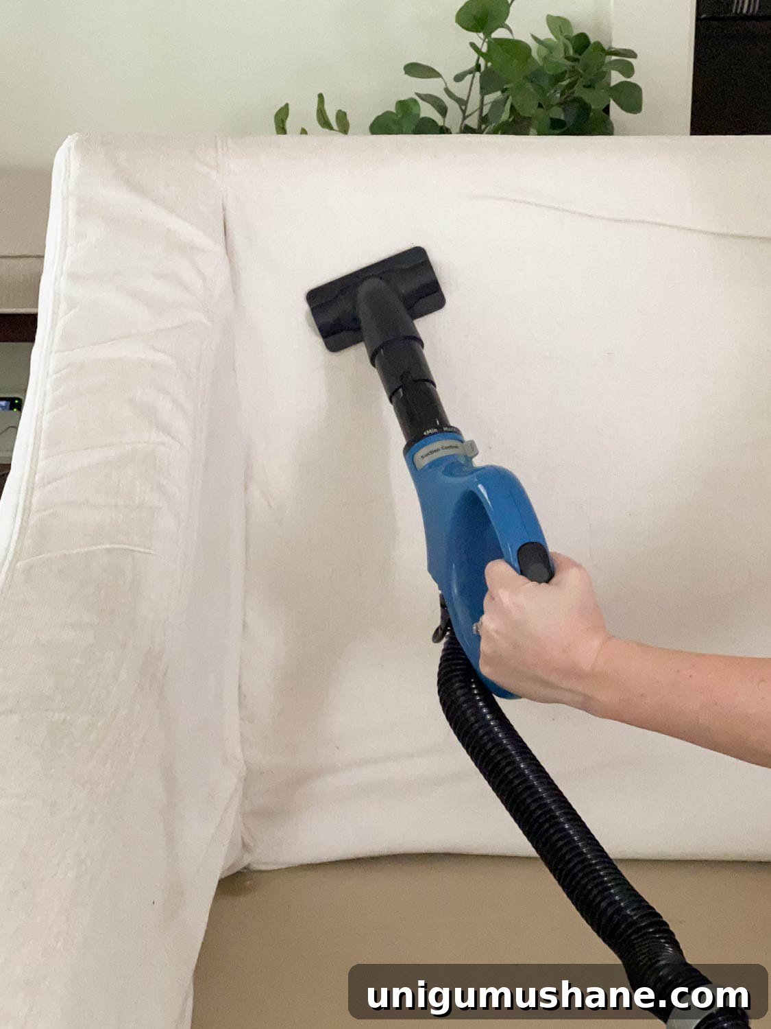 cleaning upholstery with a vacuum wand attachment