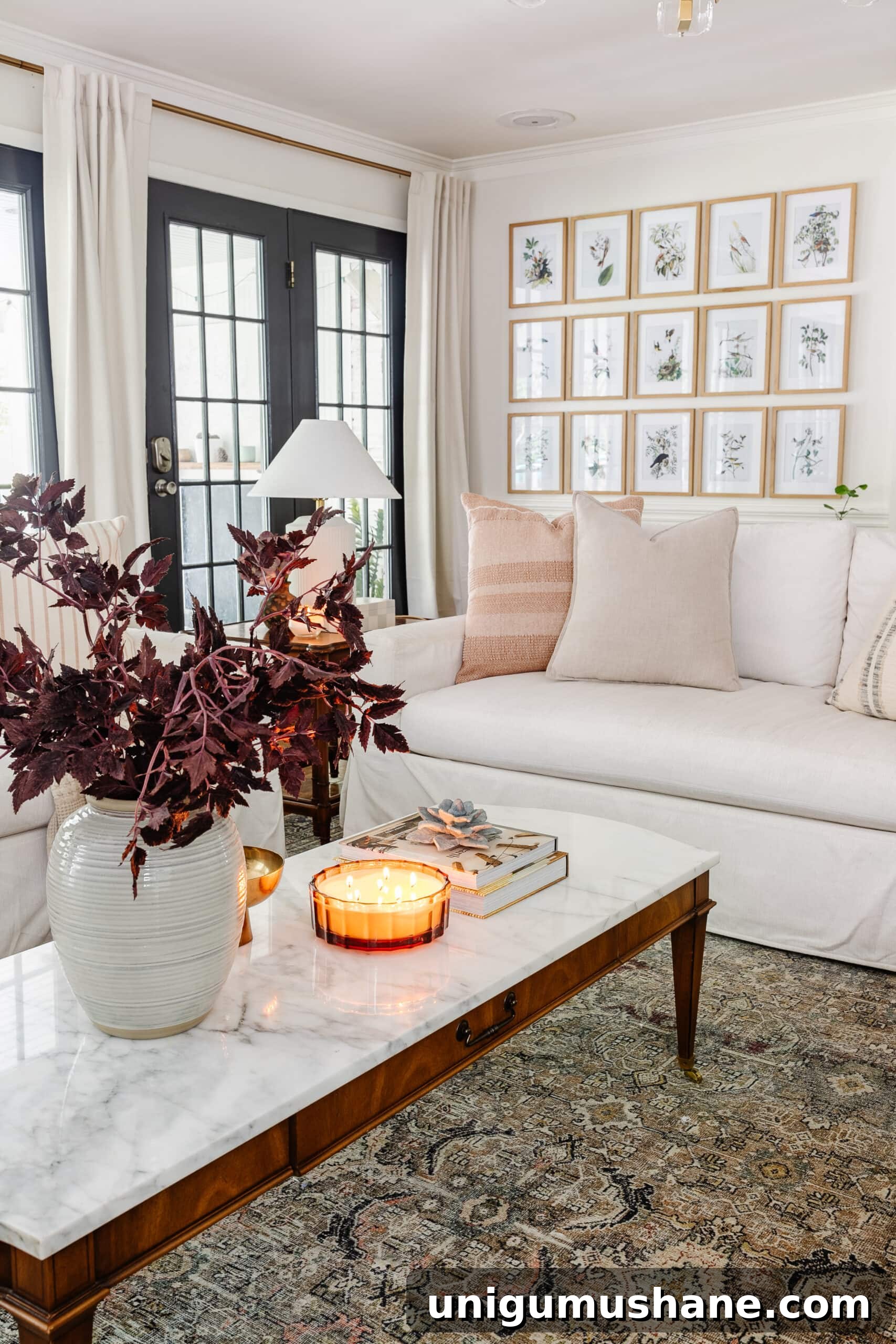 Budget Fall Living Room Decor Ideas That Save Time 21 coffee table fall decor with vase of fall stems, candle, bowl, and books in front of white sofa with neutral pillows