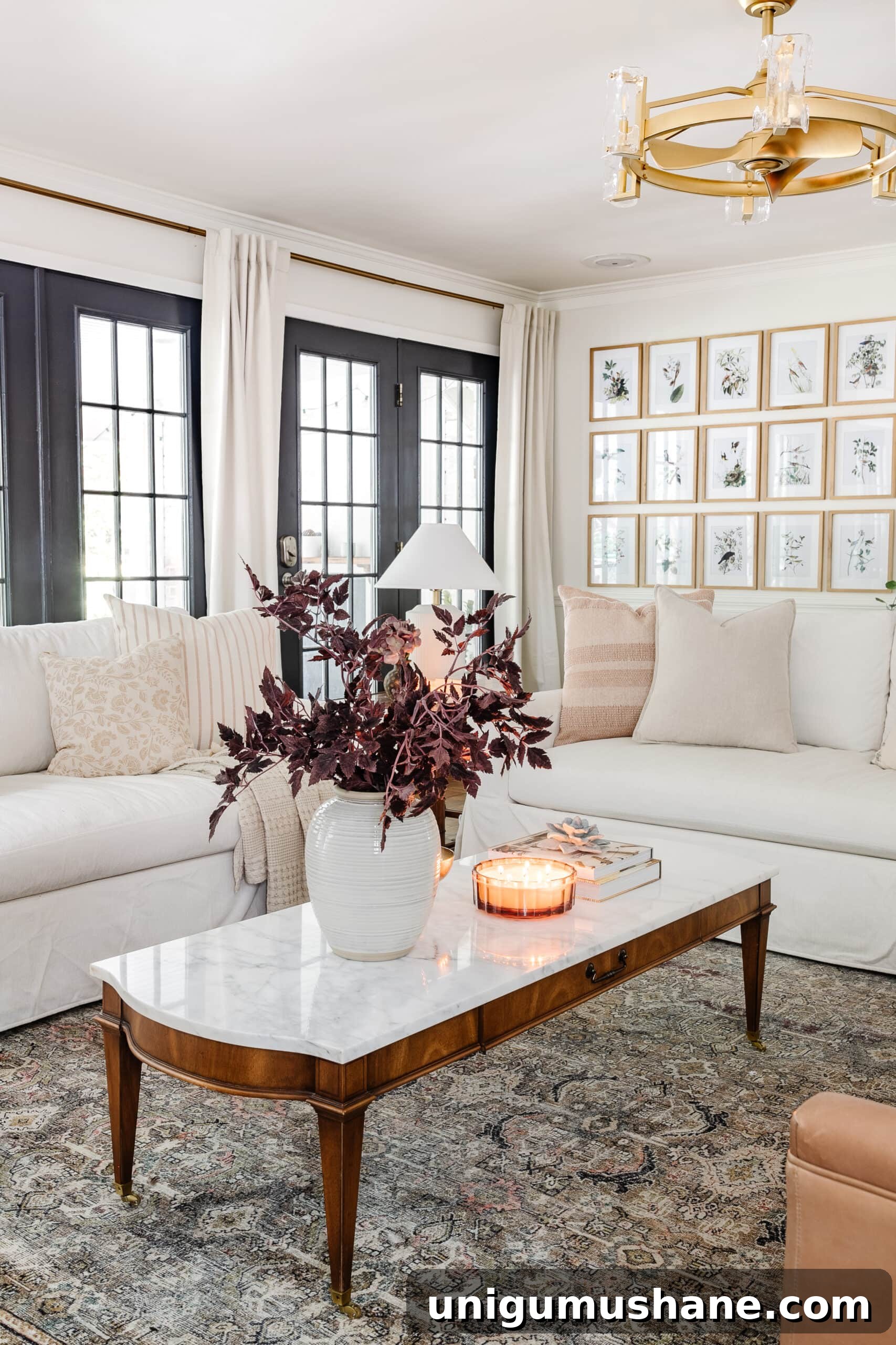 Budget Fall Living Room Decor Ideas That Save Time 7 fall decor on a coffee table with vase of fall branches, candle, brass bowl, and books in front of white couches