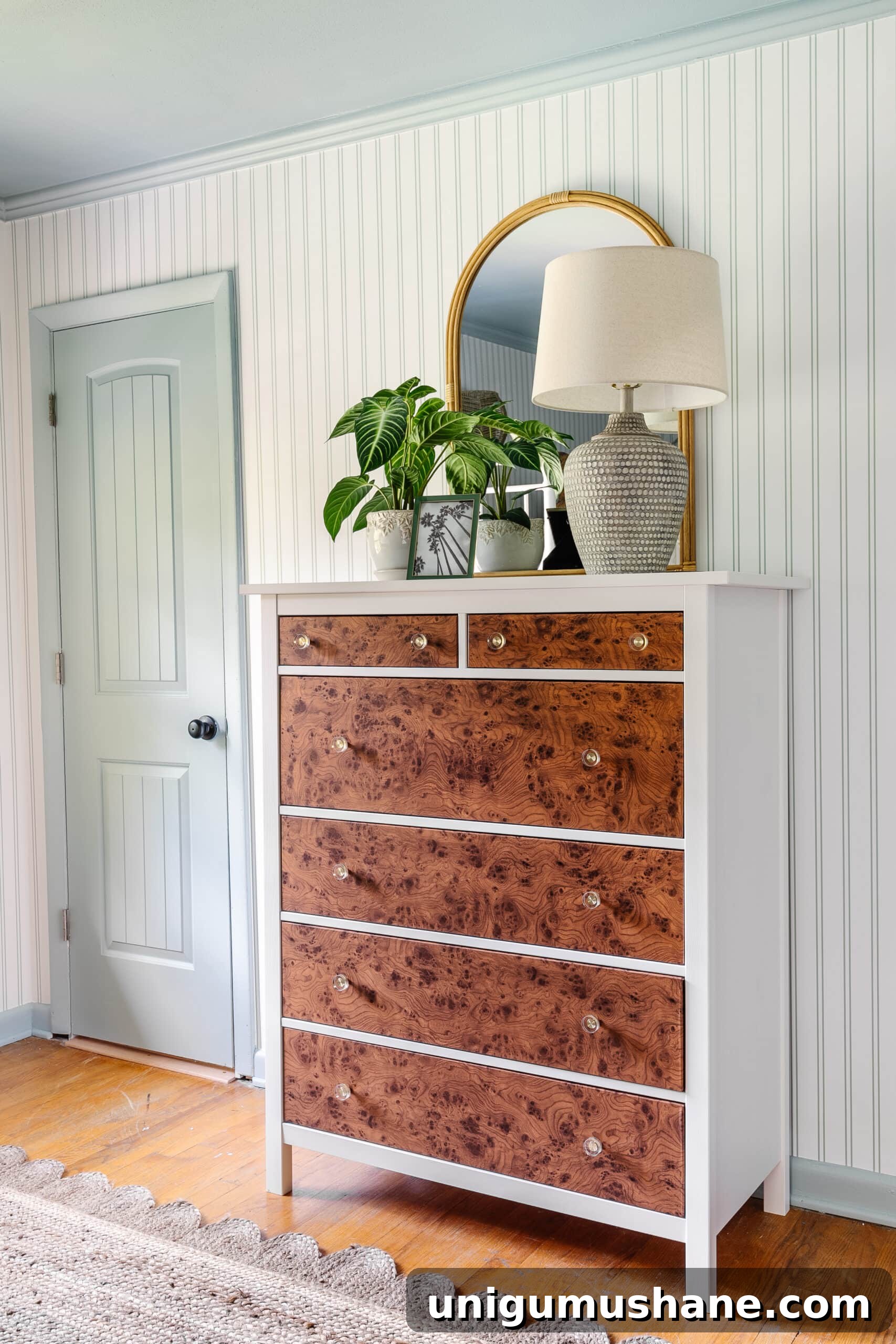Transform an IKEA Dresser with Burl Wood Contact Paper 15 IKEA dresser hack using burl wood contact paper, striped wallpaper, blue trim, rattan mirror, and coastal table lamp