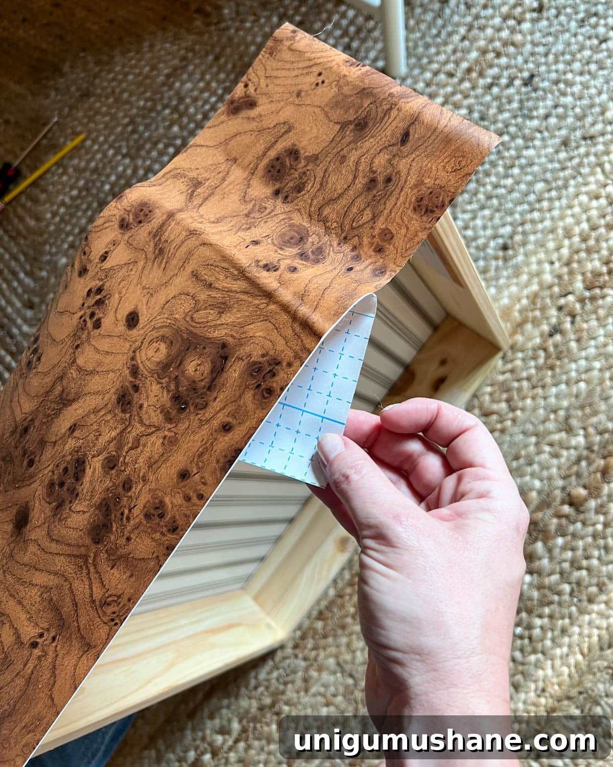 Transform an IKEA Dresser with Burl Wood Contact Paper 7 sticking burl wood contact paper to dresser drawer front