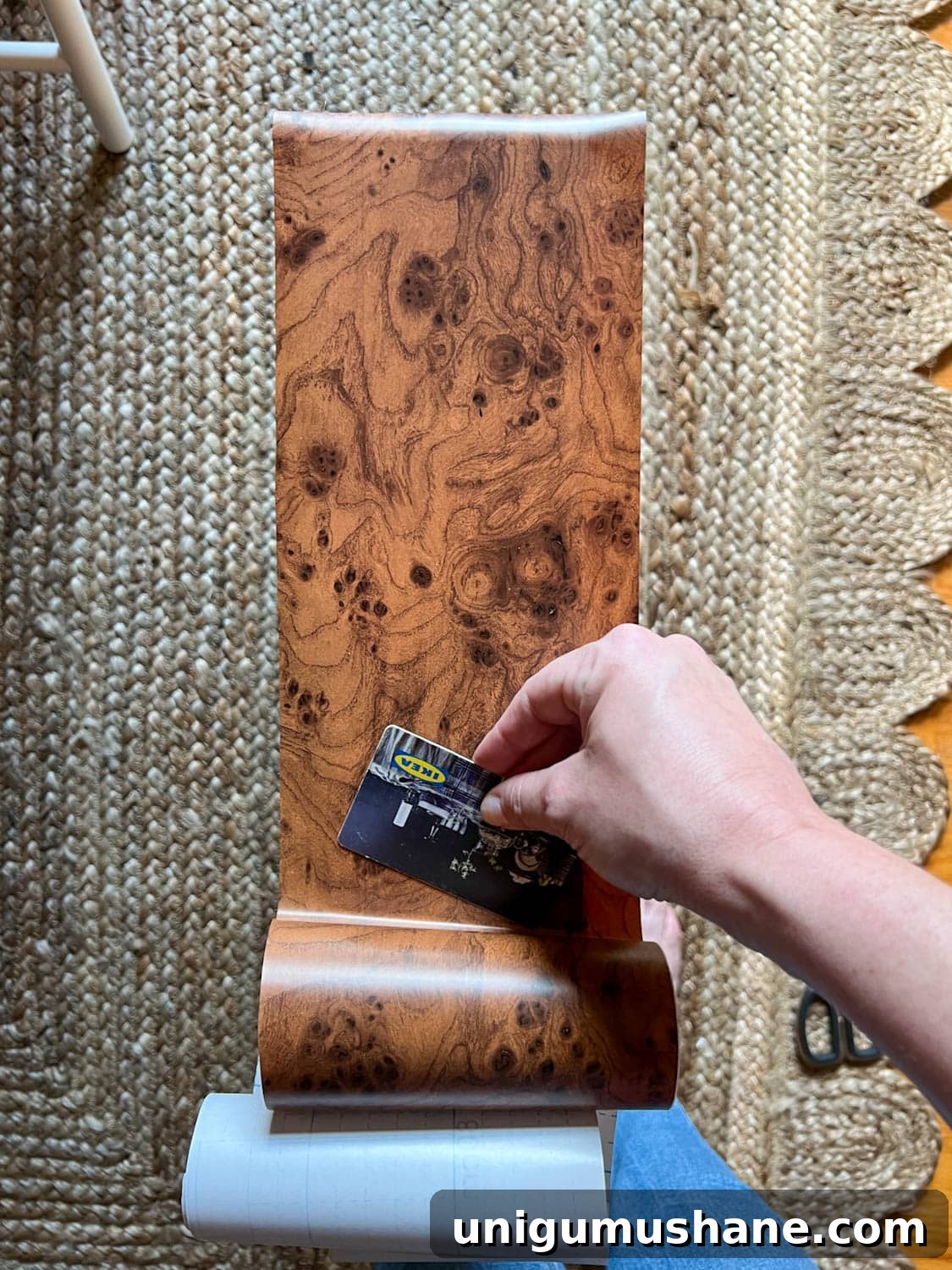 Transform an IKEA Dresser with Burl Wood Contact Paper 8 smoothing out burl wood contact paper to dresser drawer front