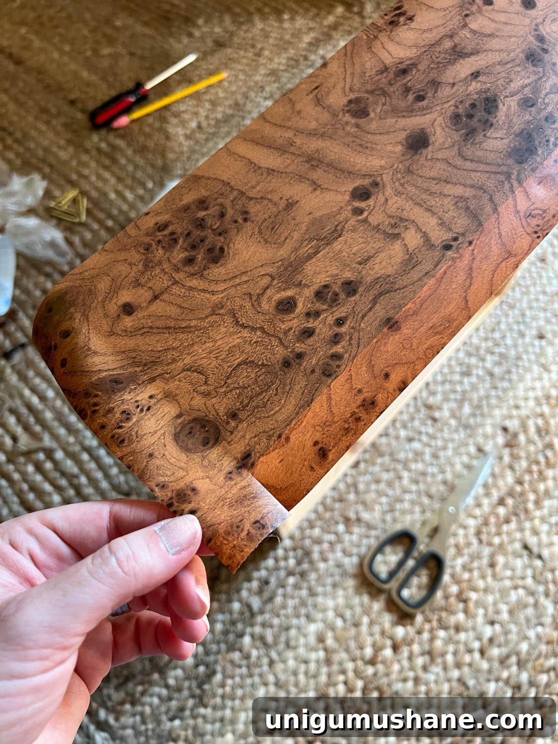 Transform an IKEA Dresser with Burl Wood Contact Paper 9 cutting excess contact paper for furniture wrapping
