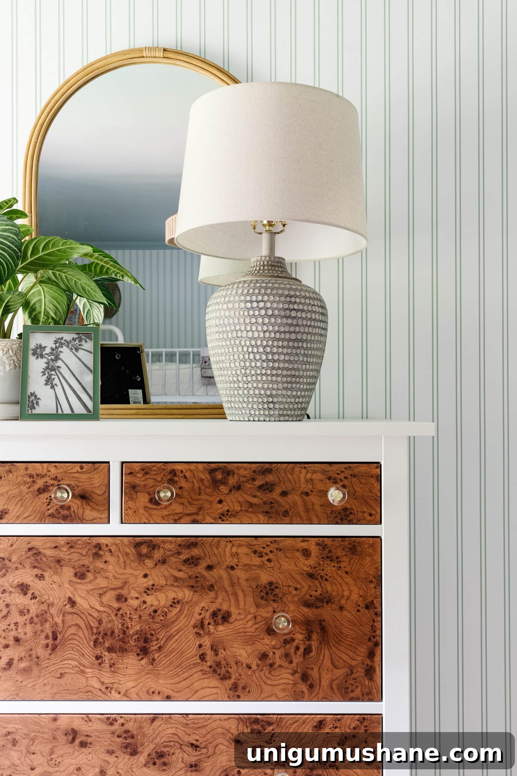Beach-Themed Triple Bunk Bed Makeover for Teens 18 table lamp on IKEA dresser with rattan mirror, potted plant, and picture frame