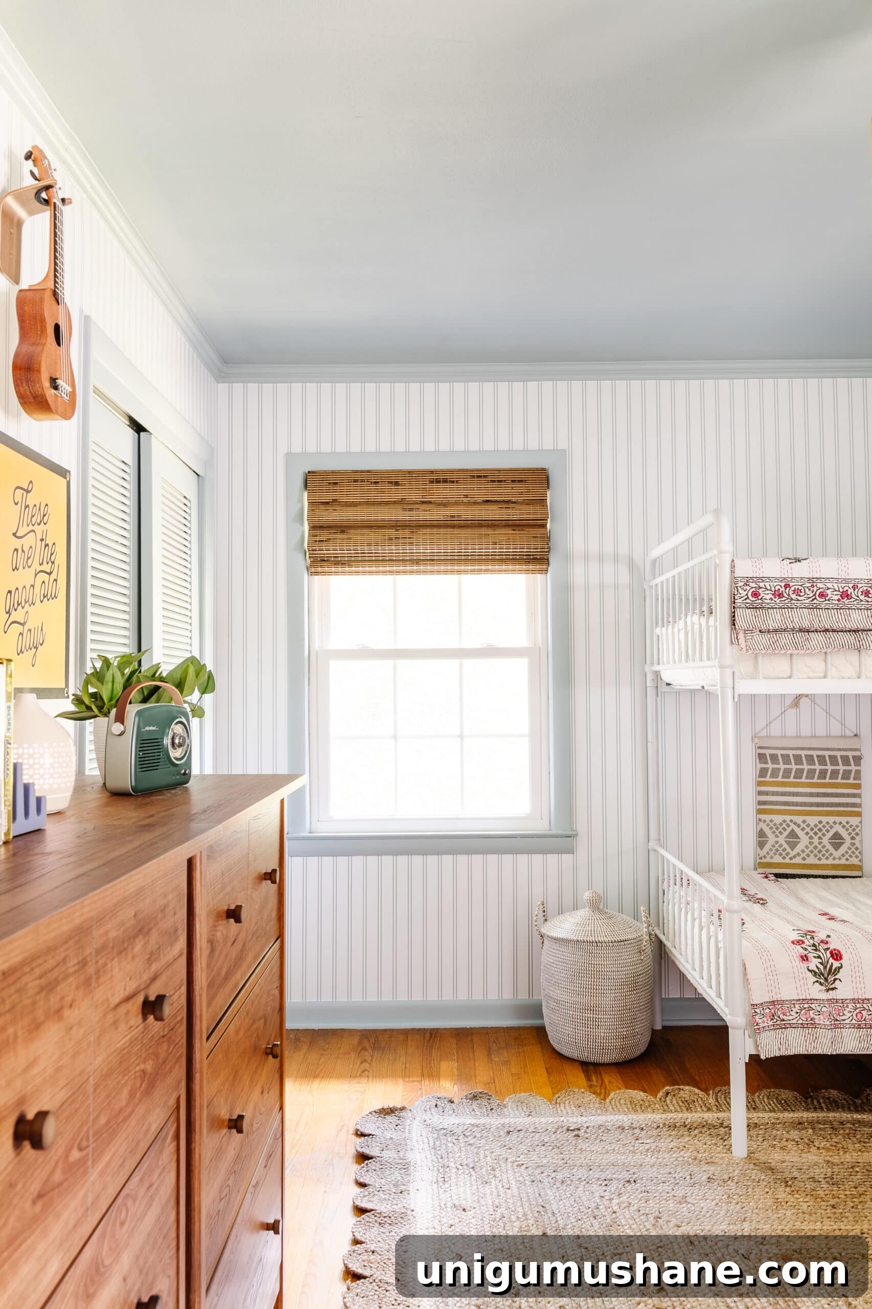Beach-Themed Triple Bunk Bed Makeover for Teens 23 bamboo window shade, striped wallpaper, blue trim, and jute rug in beach themed bedroom for teenagers