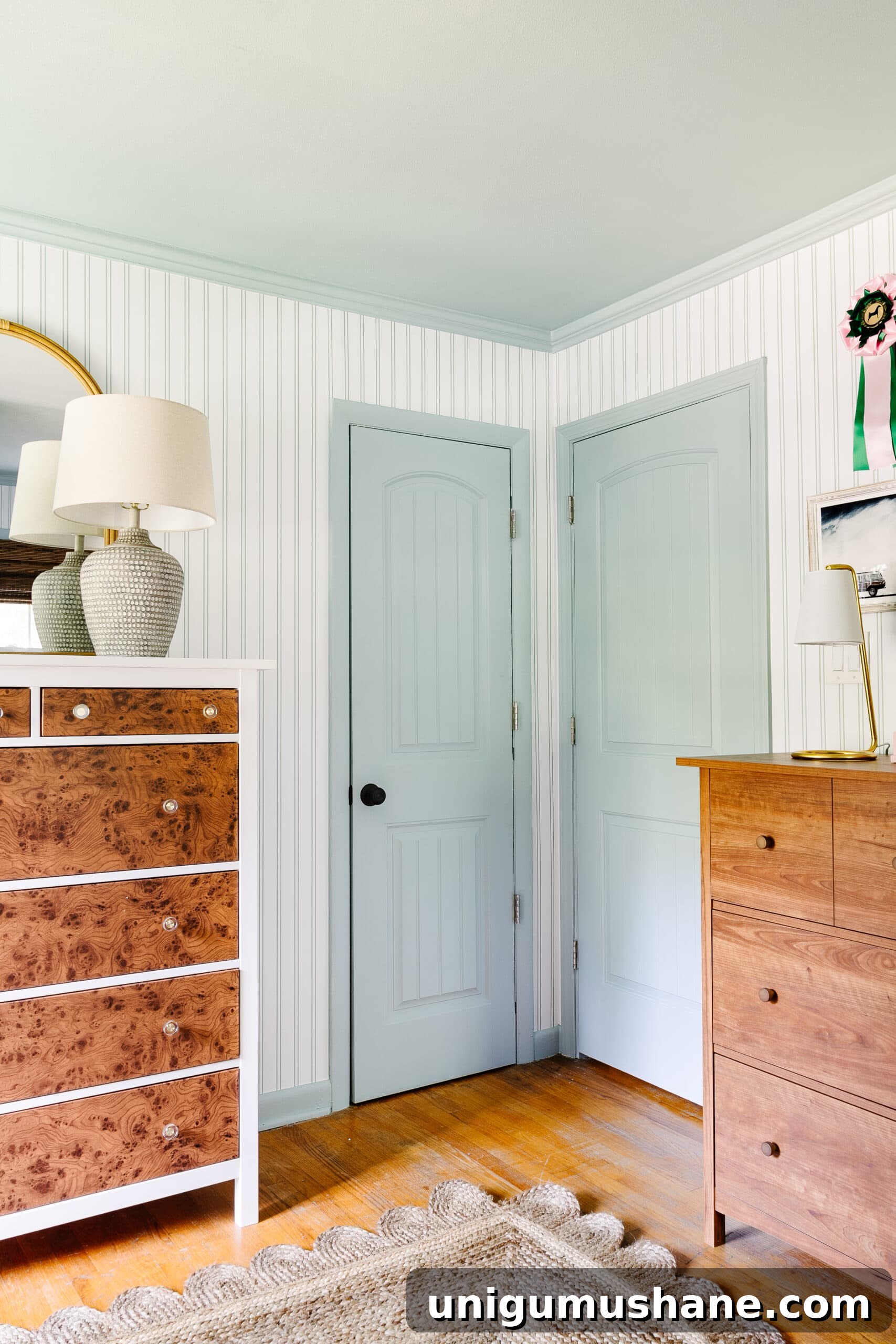 Beach-Themed Triple Bunk Bed Makeover for Teens 6 blue doors, trim, and ceiling with striped wallpaper and wooden dressers in shared teenage beach themed bedroom