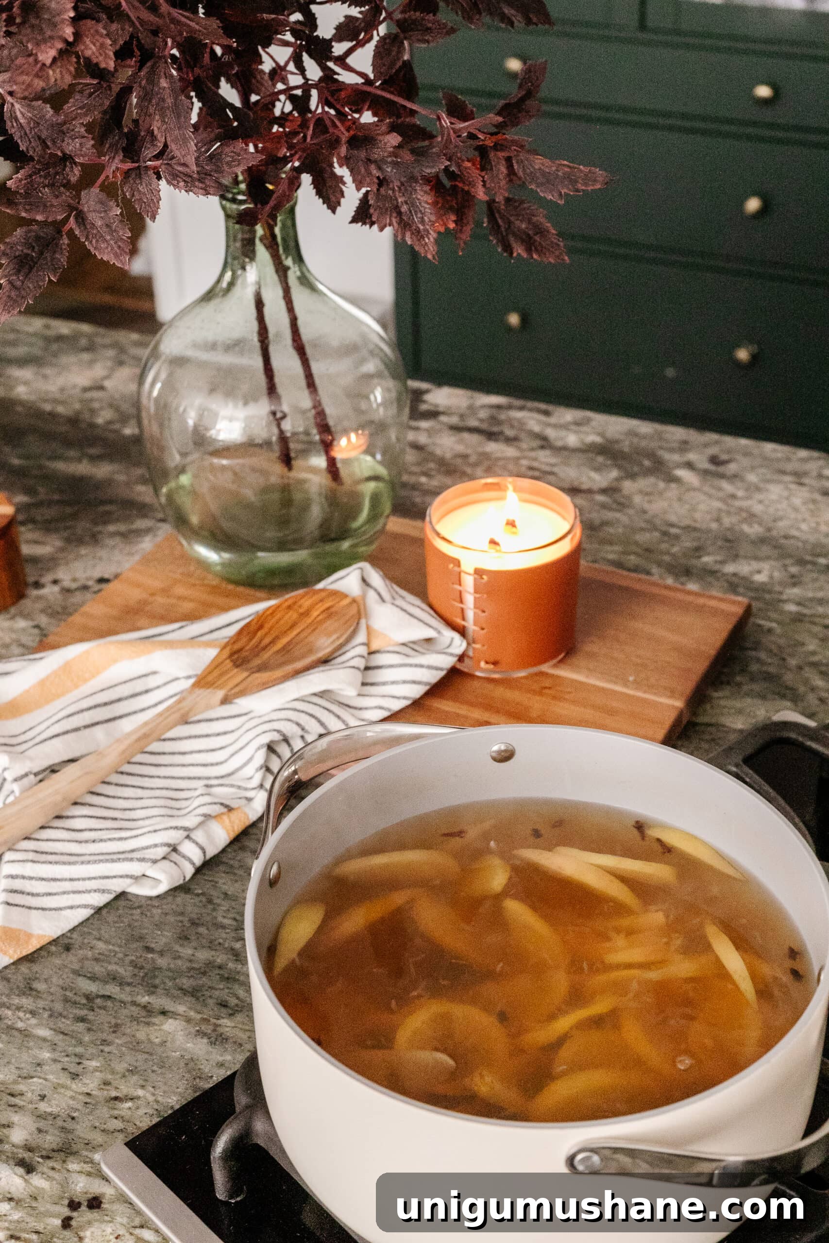 16 Natural Home Fragrance Hacks for a Fresh Smelling House 6 stovetop potpourri with vase of fall leaves to make your house smell good naturally