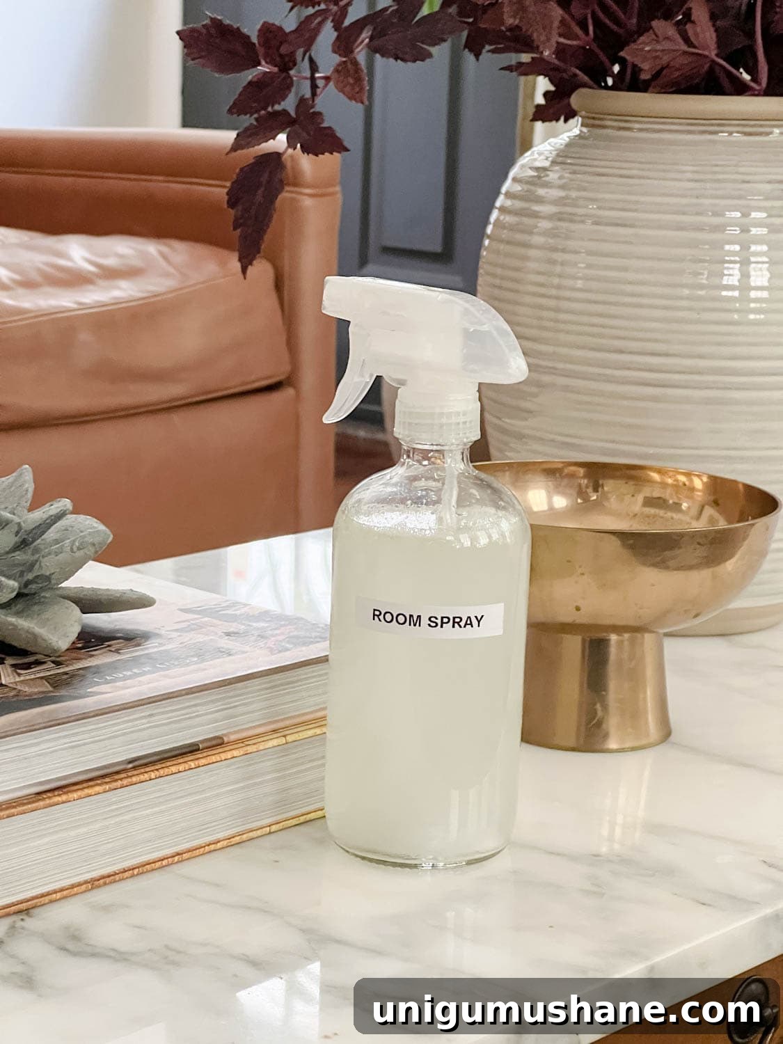 16 Natural Home Fragrance Hacks for a Fresh Smelling House 7 spray bottle of room spray on a living room coffee table