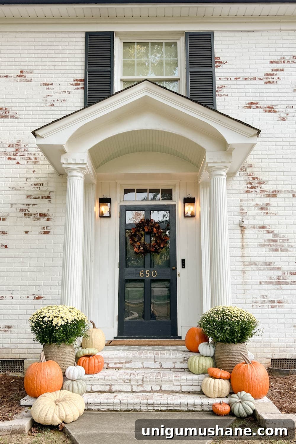 Realistic Faux Pumpkins for Fall 2024 Home Decor 2 front porch decorated for fall with fake pumpkins and mums on porch steps with limewashed brick