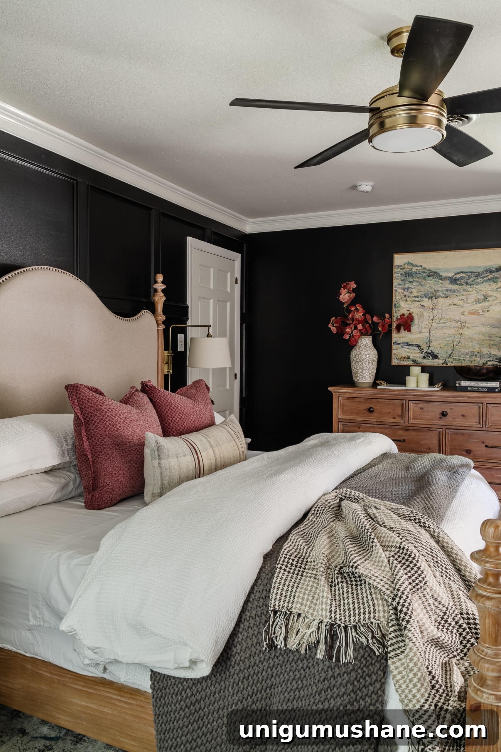 10 Affordable Cozy Bedroom Ideas to Improve Sleep 2 cozy bedroom with black walls, comfy bedding, and wooden dresser