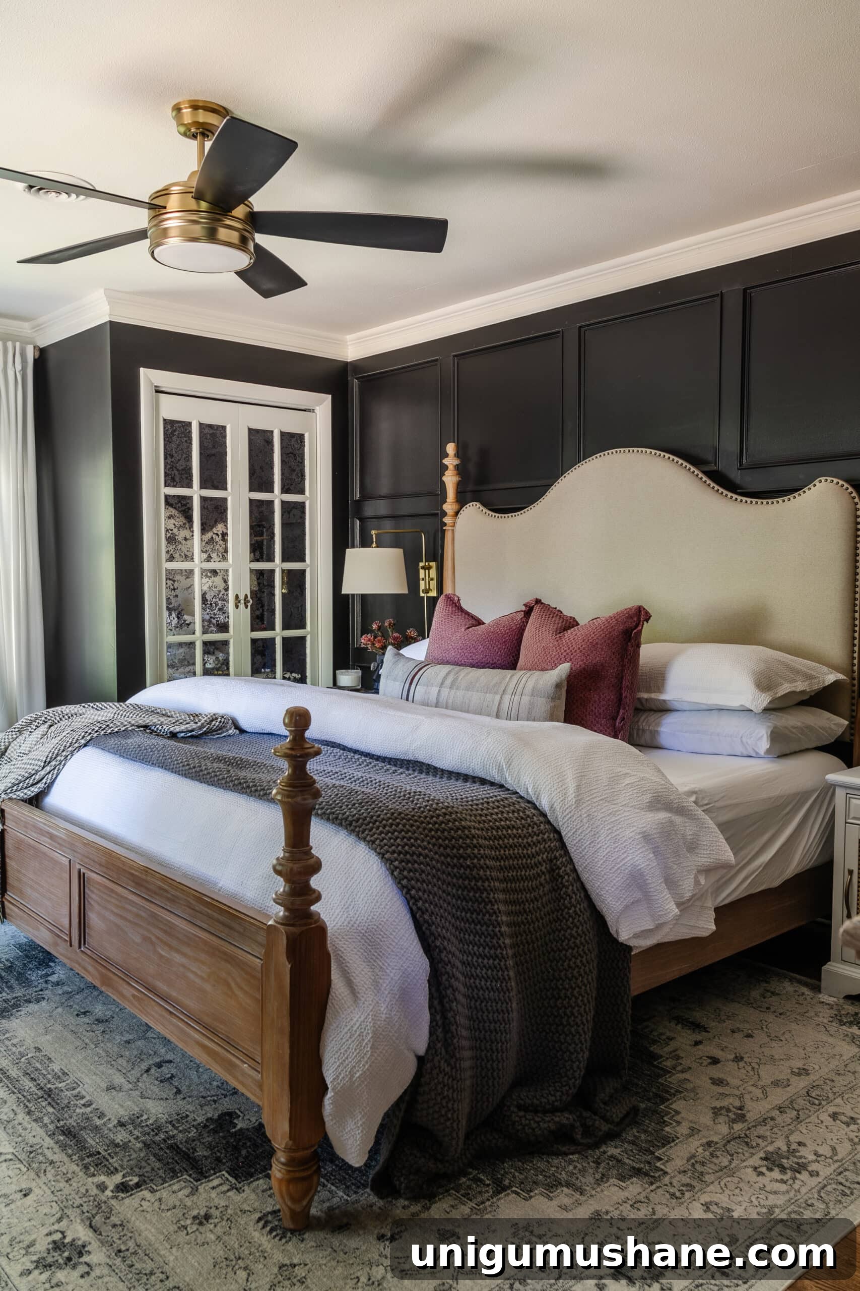 10 Affordable Cozy Bedroom Ideas to Improve Sleep 5 bedroom with black walls, fluffy bedding, wood and upholstered bed, and ceiling fan