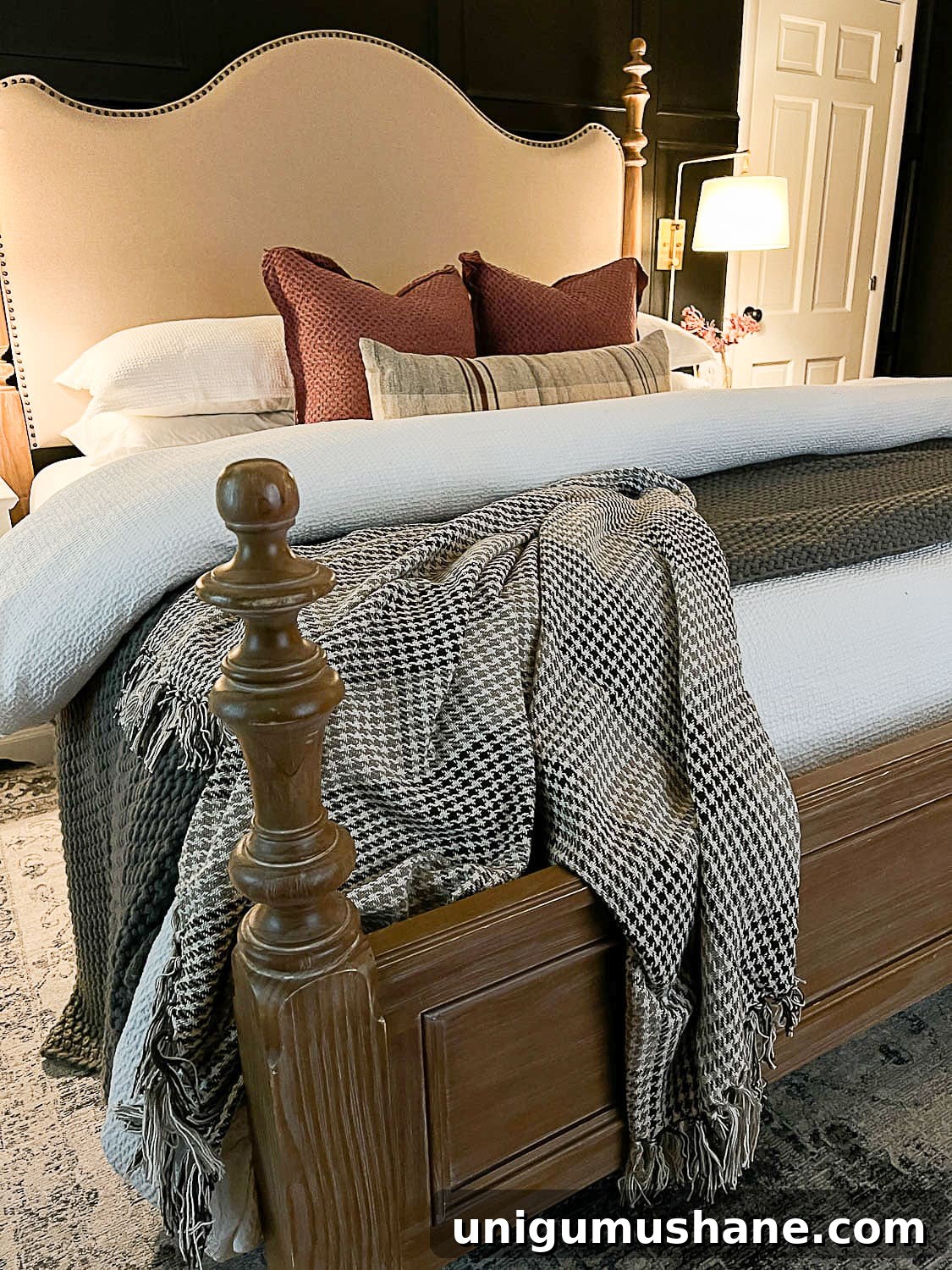 10 Affordable Cozy Bedroom Ideas to Improve Sleep 8 wood and upholstered bed with mauve pillows and houndstooth blanket