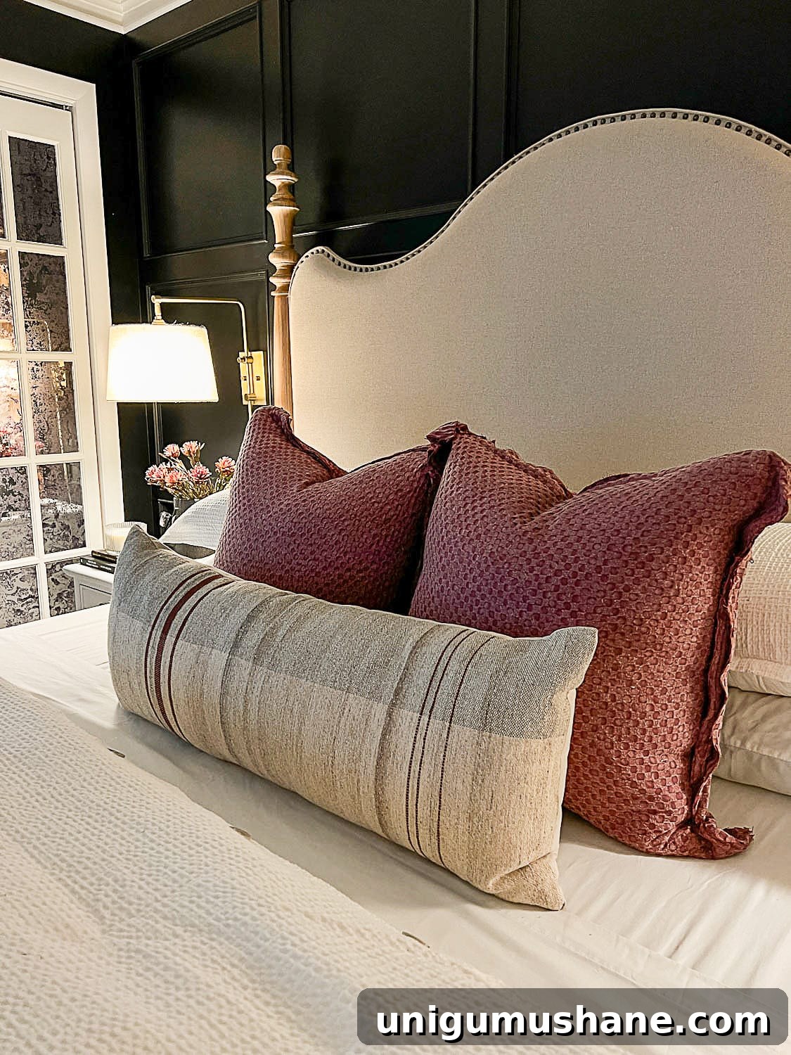 10 Affordable Cozy Bedroom Ideas to Improve Sleep 9 fall pillows on bed with lamp light