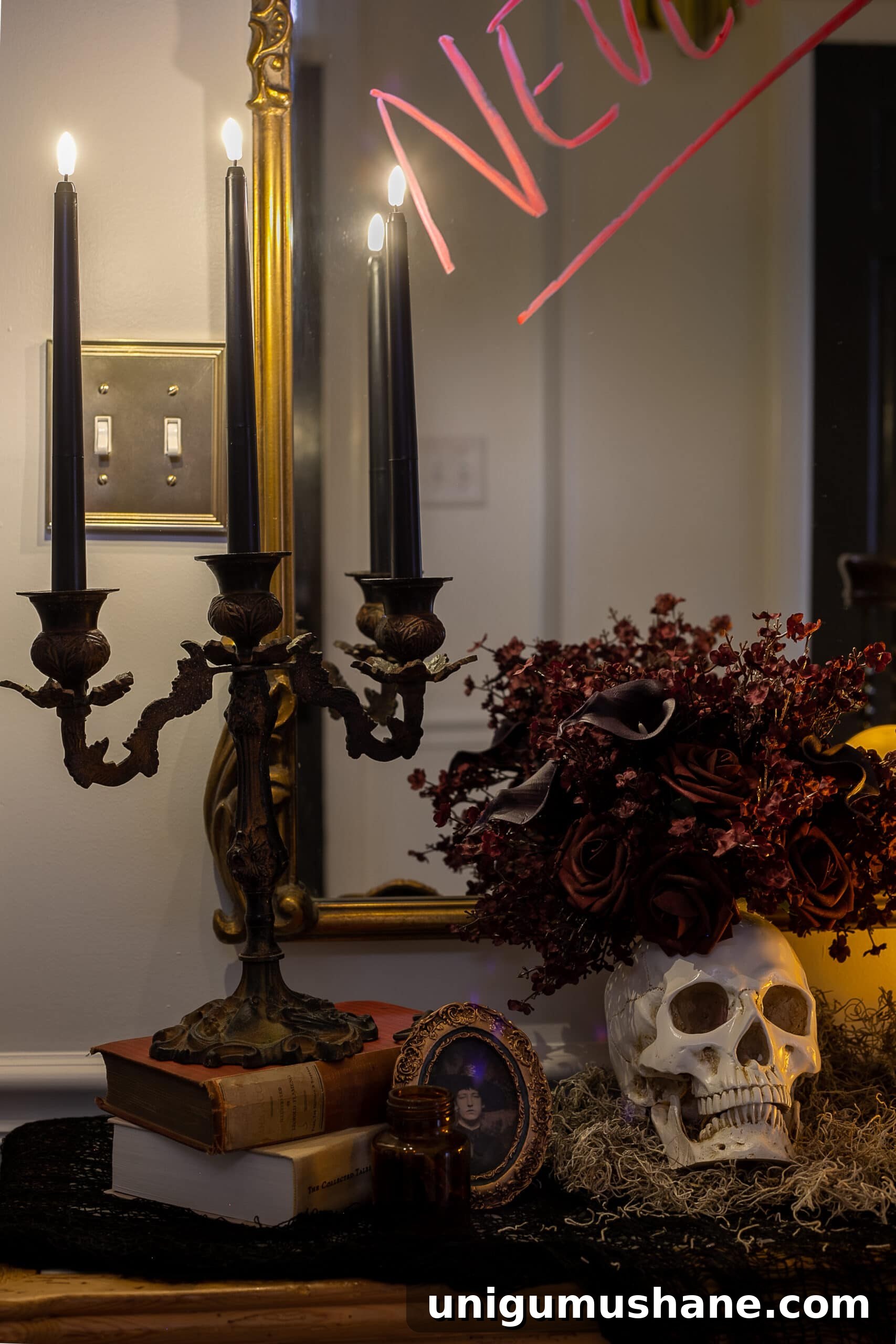 DIY Haunted House Entryway Ideas for Halloween 10 candelabra with flameless candles, vintage picture frame, and skull vase