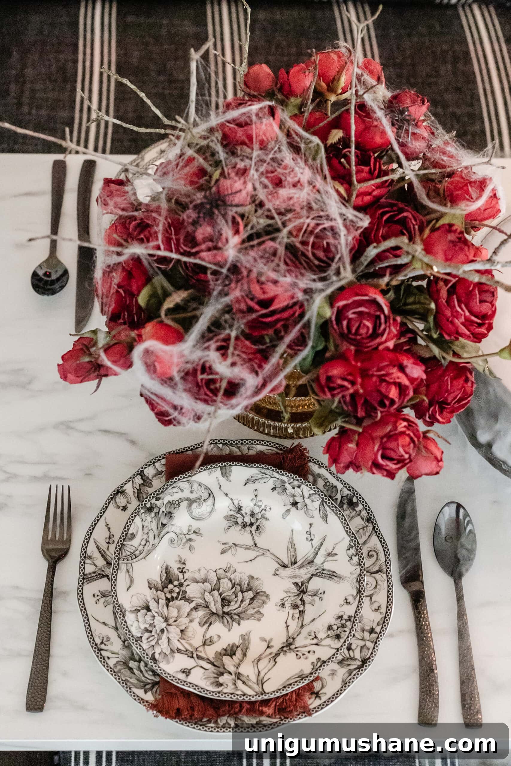 Murder Mystery Party Table Decor Ideas for Halloween 11 black toile plates and hammered black flatware Halloween place setting