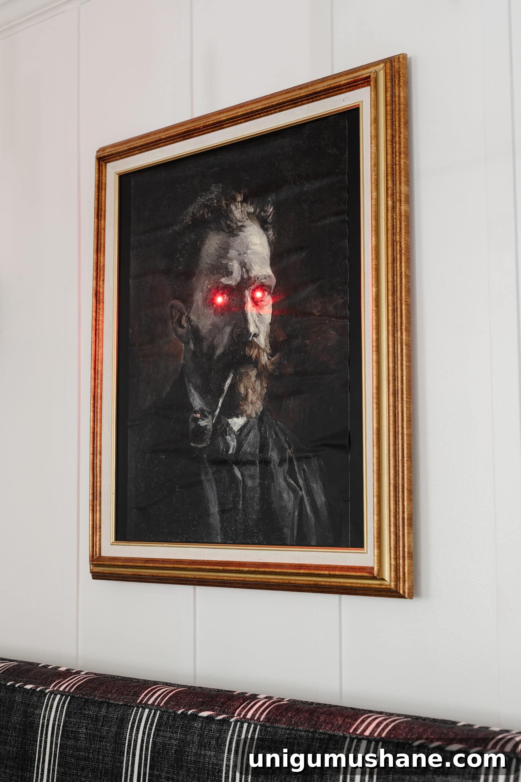 DIY Spooky Halloween Decor Using a Thrifted Picture Frame 11 creepy Halloween art with glowing eyes in a gold picture frame for DIY Halloween wall decor