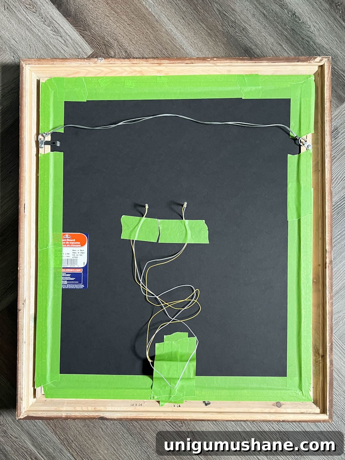 DIY Spooky Halloween Decor Using a Thrifted Picture Frame 9 red battery lights taped to the back of a Halloween art portrait