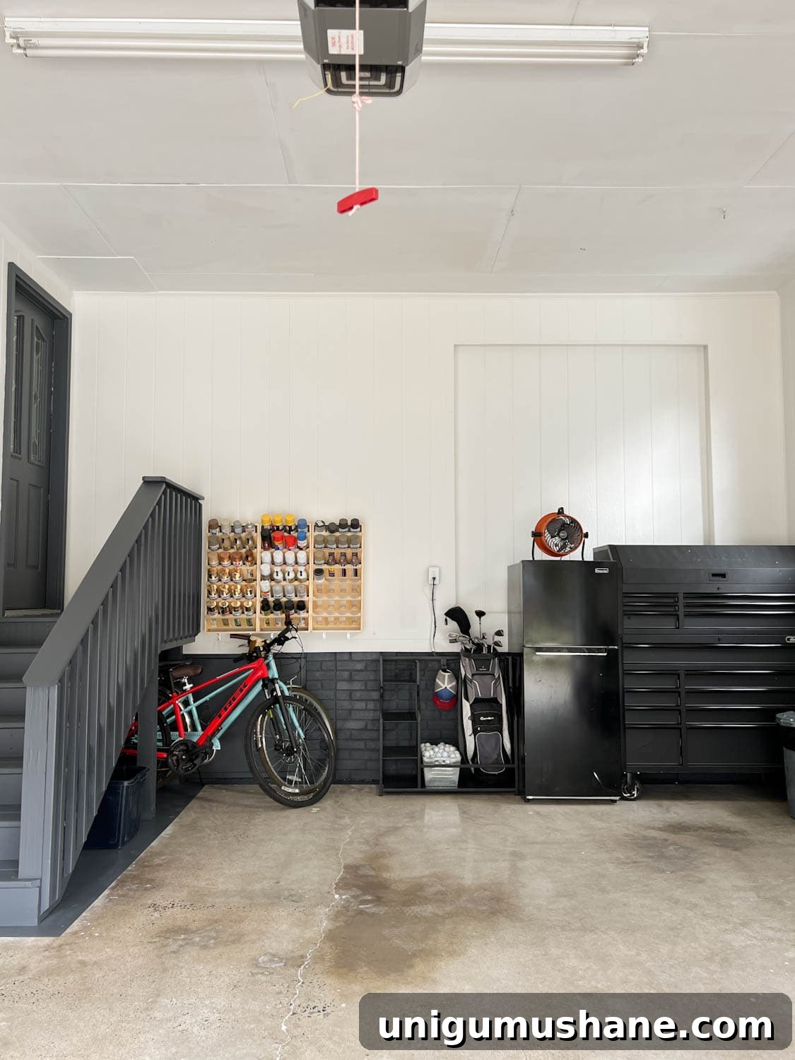 Smart Garage Storage Ideas to Maximize Space 2 garage after with white walls and black trim and repurposed concrete floor