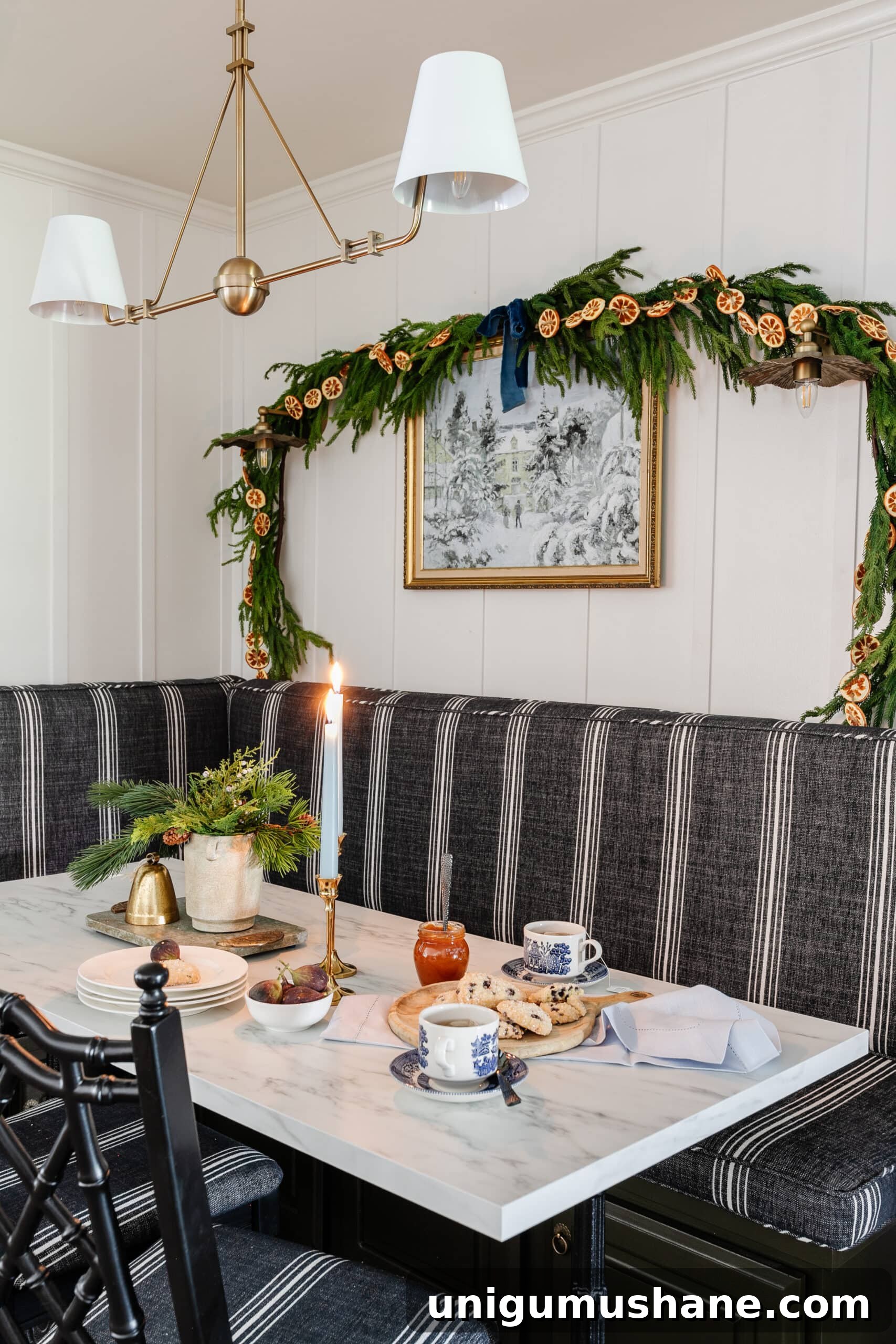 Free Winter Art Printable You Can Frame Anywhere 5 winter scene painting on breakfast nook wall with pine and orange garland