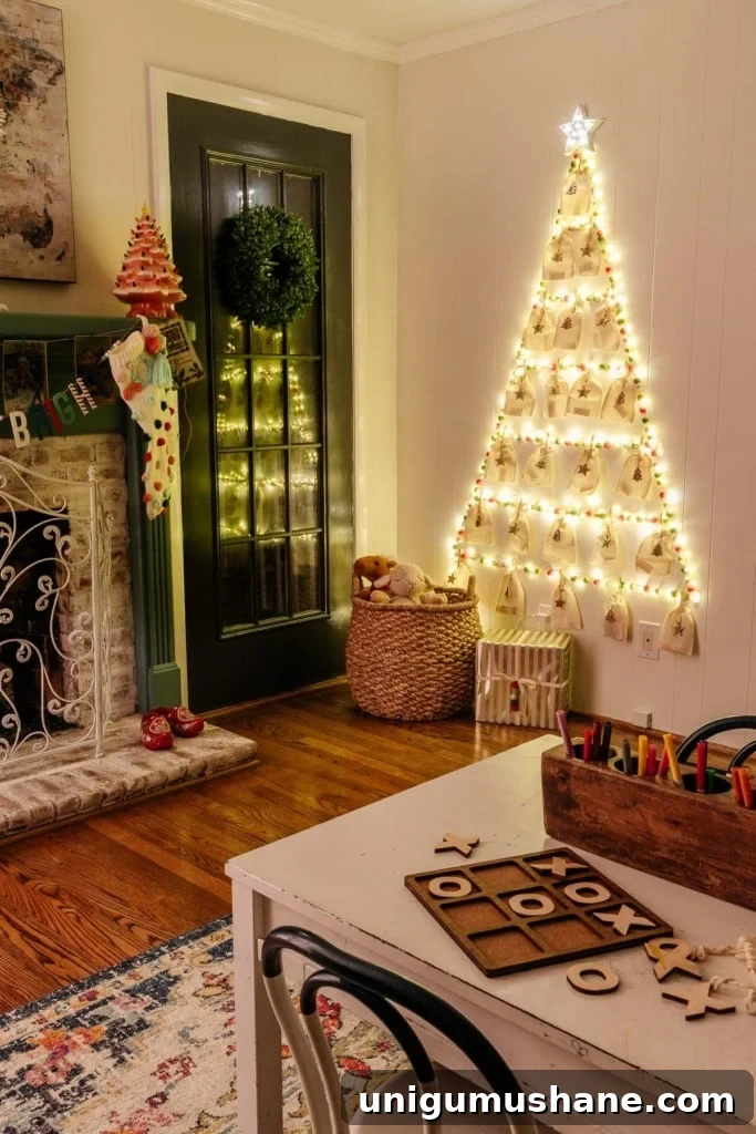 18 Christmas Wall Decor Ideas with Holiday Art Printables 13 Christmas tree wall display made with fairy lights, pom pom garland, and Command hooks in a playroom